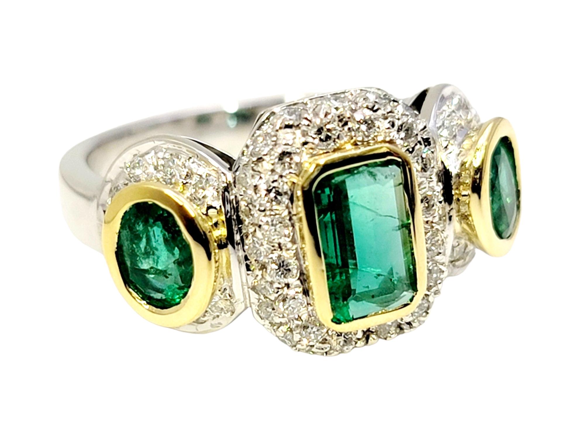 Emerald Cut Natural Emerald Three Stone Ring with Pave Diamond Halos in 18 Karat Gold For Sale