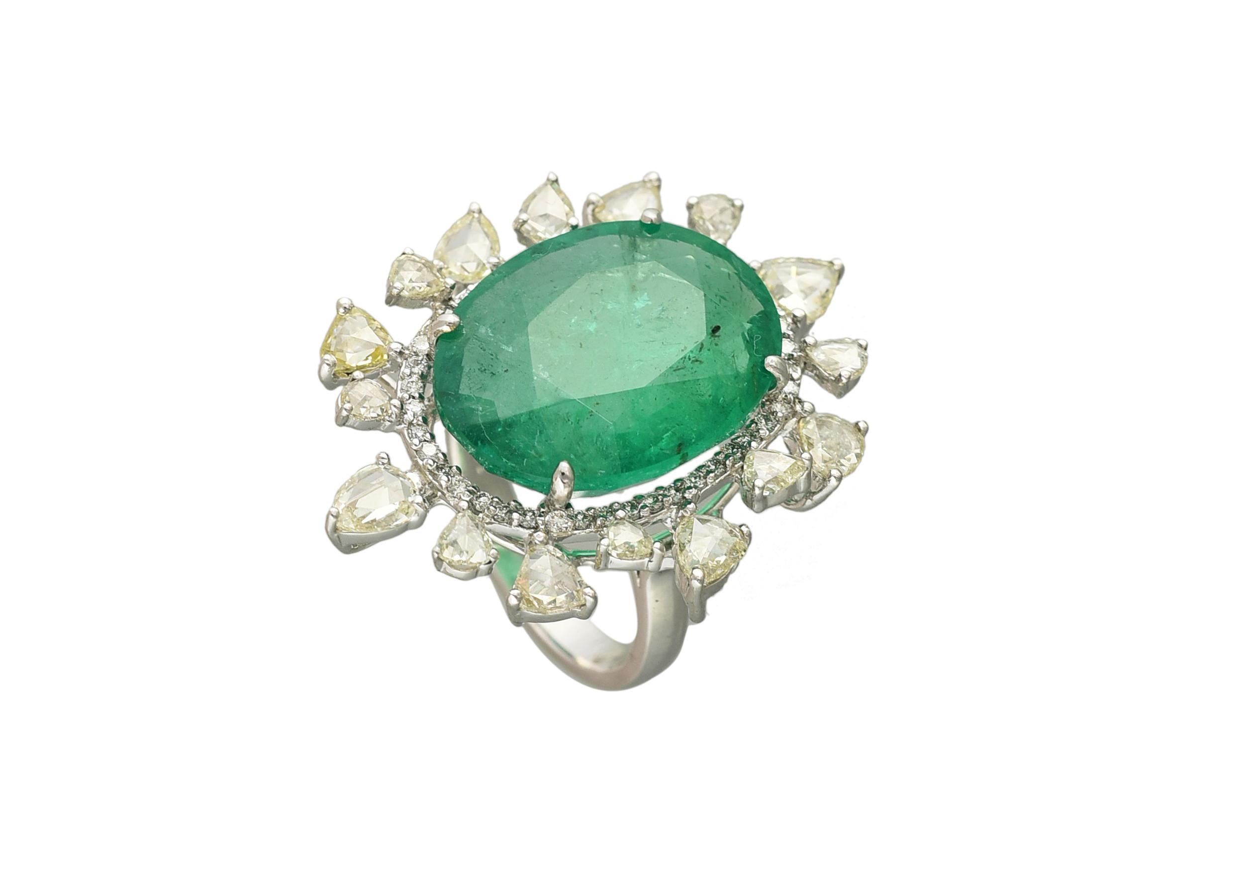 A very gorgeous Emerald Cocktail ring set in 18K white gold & Diamonds. The emerald is natural and weighs 13.70 carats. The weight of the Rose Cut Diamonds is 2.65 carats. The dimensions of the ring are 2.00cm x 1.50cm x 1.00cm (L x W x D). The ring