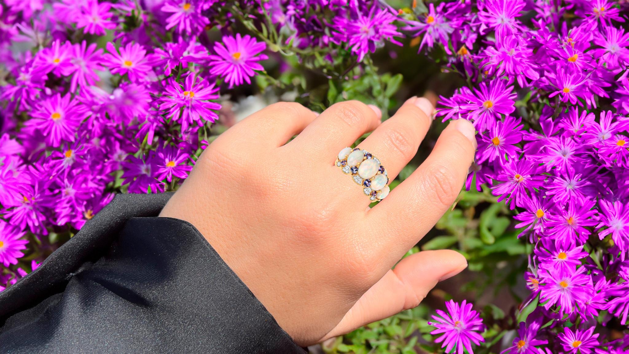 It comes with the Gemological Appraisal by GIA GG/AJP
All Gemstones are Natural
5 Ethiopian Opals = 2.35 Carats
8 Tanzanites = 0.45 Carats
30 Diamonds = 0.10 Carats
Metal: 14K Yellow Gold
Ring Size: 8* US
*It can be resized complimentary