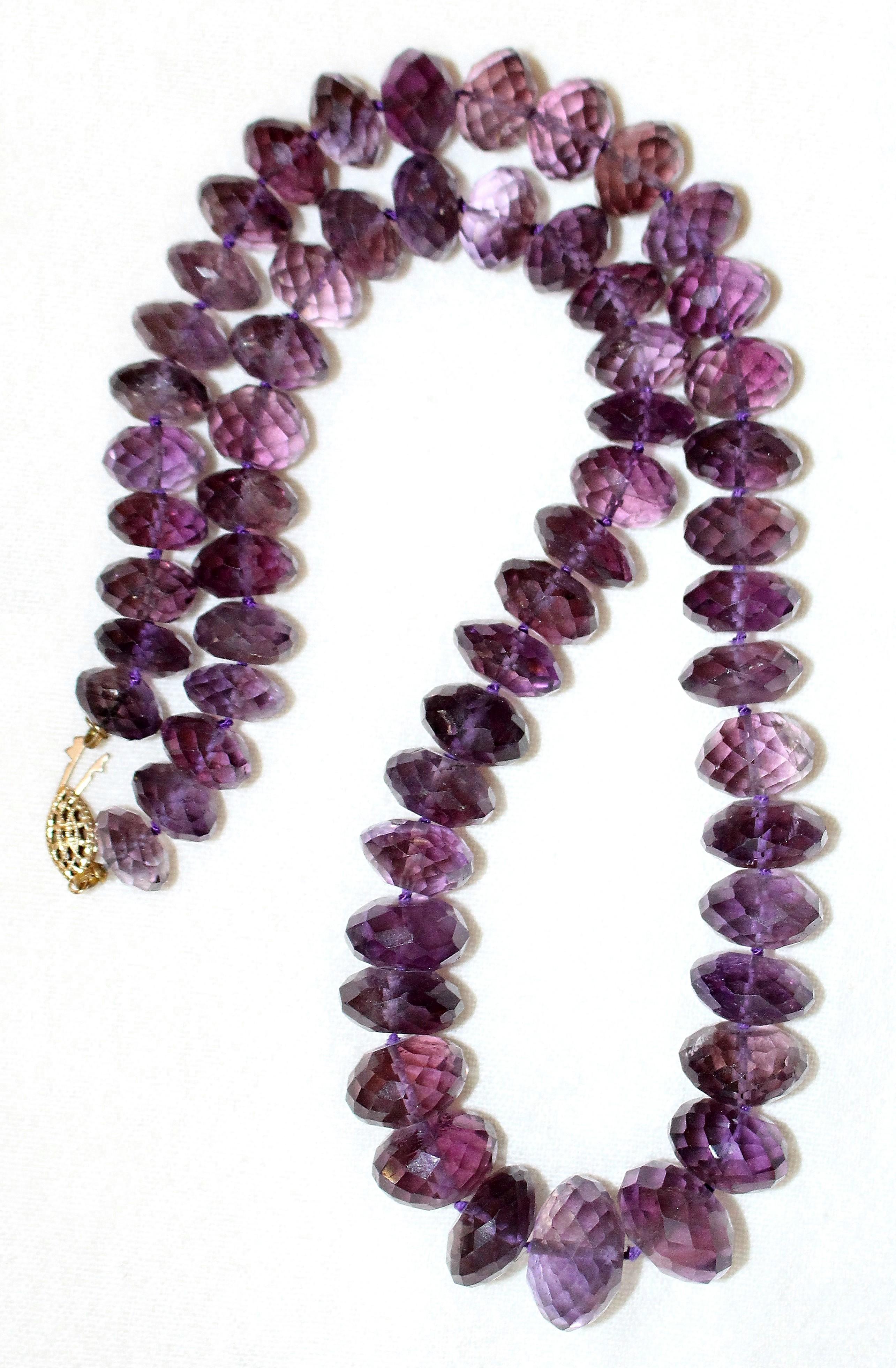 Circa 1960s to 1970s necklace of hand-knotted large, faceted natural amethyst beads in graduated sizes.  The necklace measures 21.5