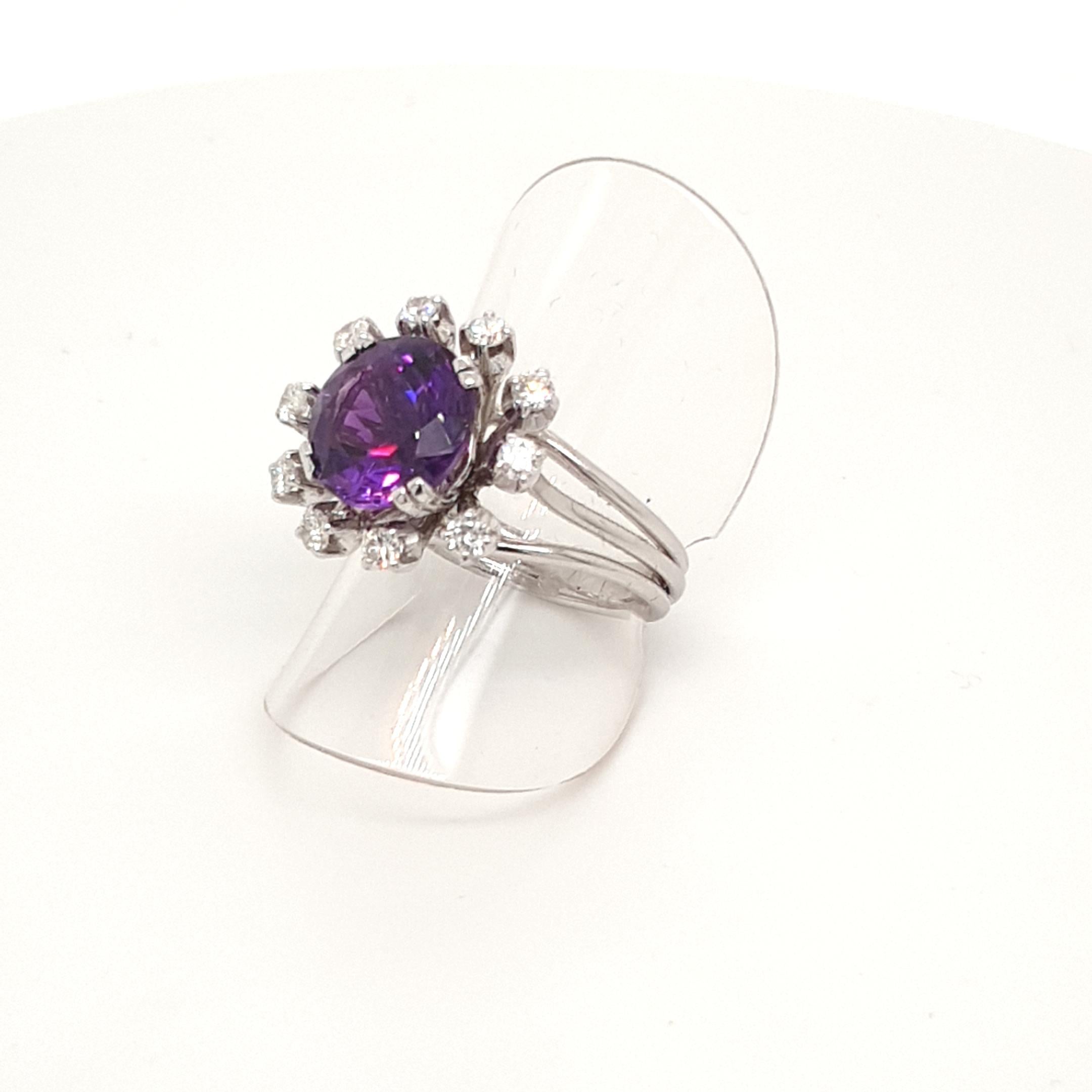 This Natural Faceted Purple Amethyst Ring with 18 Carat White Gold surrounded from 10 Diamonds is totally handmade. 
Details:
ringsize: 7 (54)
Fac. Amethyst, 10 mm round, 3.55 ct.
10 diamonds: 0,4 ct.