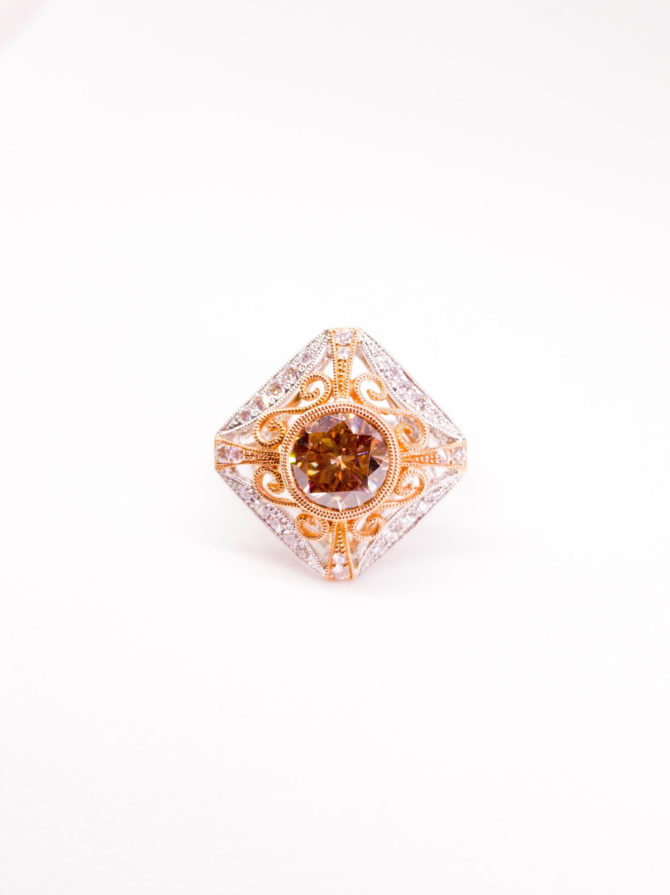 Natural Fancy Cognac / Champagne, and White Diamond Filigree Ring in 14 Karat White and Rose Gold. The Ring features a bezel set Round Brilliant Diamond of Natural Fancy Color and Vs2 - Si1 Clarity and a weight of 1.80 Carats. The Ring is also set