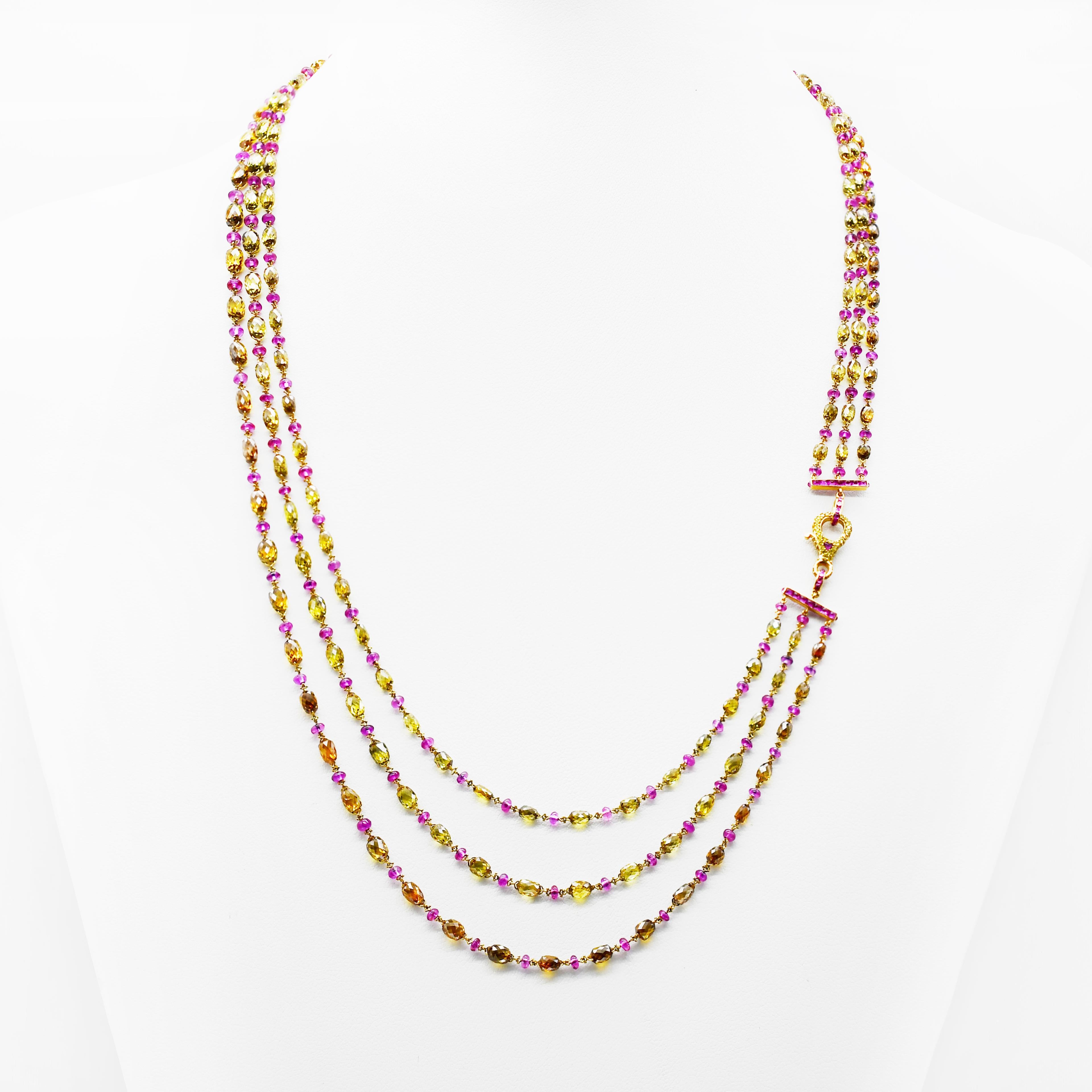 This Three Line Necklace Features 18 Karat Yellow Gold With A Combination Of  Non-Heated Burmish Ruby And Mix Fancy Color Diamond Briolette with Studded Lock.
It Has Total 45.37 Carats In House Polished Natural Fancy Color Diamond Briolettes and
