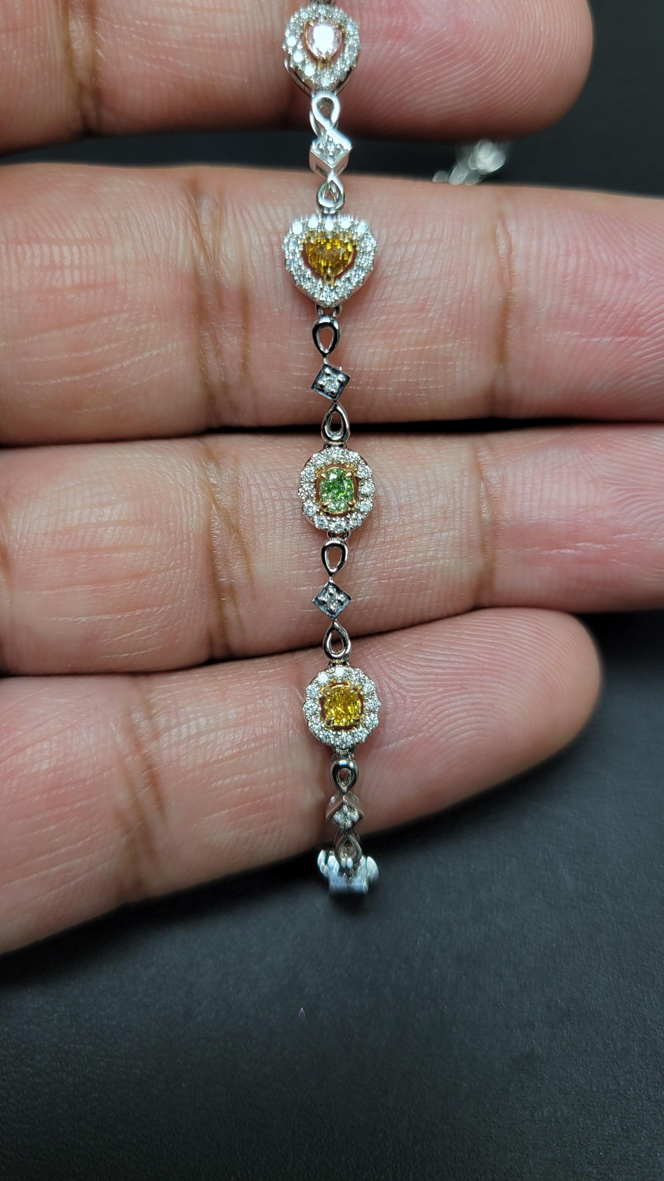 Gorgeous multi color diamond bracelet set in 7.08grams of the finest 18K/W Gold. This gorgeous bracelet consists of Pink, Yellow, and Green diamonds which are mostly Oval, some Pear shapes and Hearts. 

Lot #: 04186

18KW/P Gold: 7.08g

Fancy Color