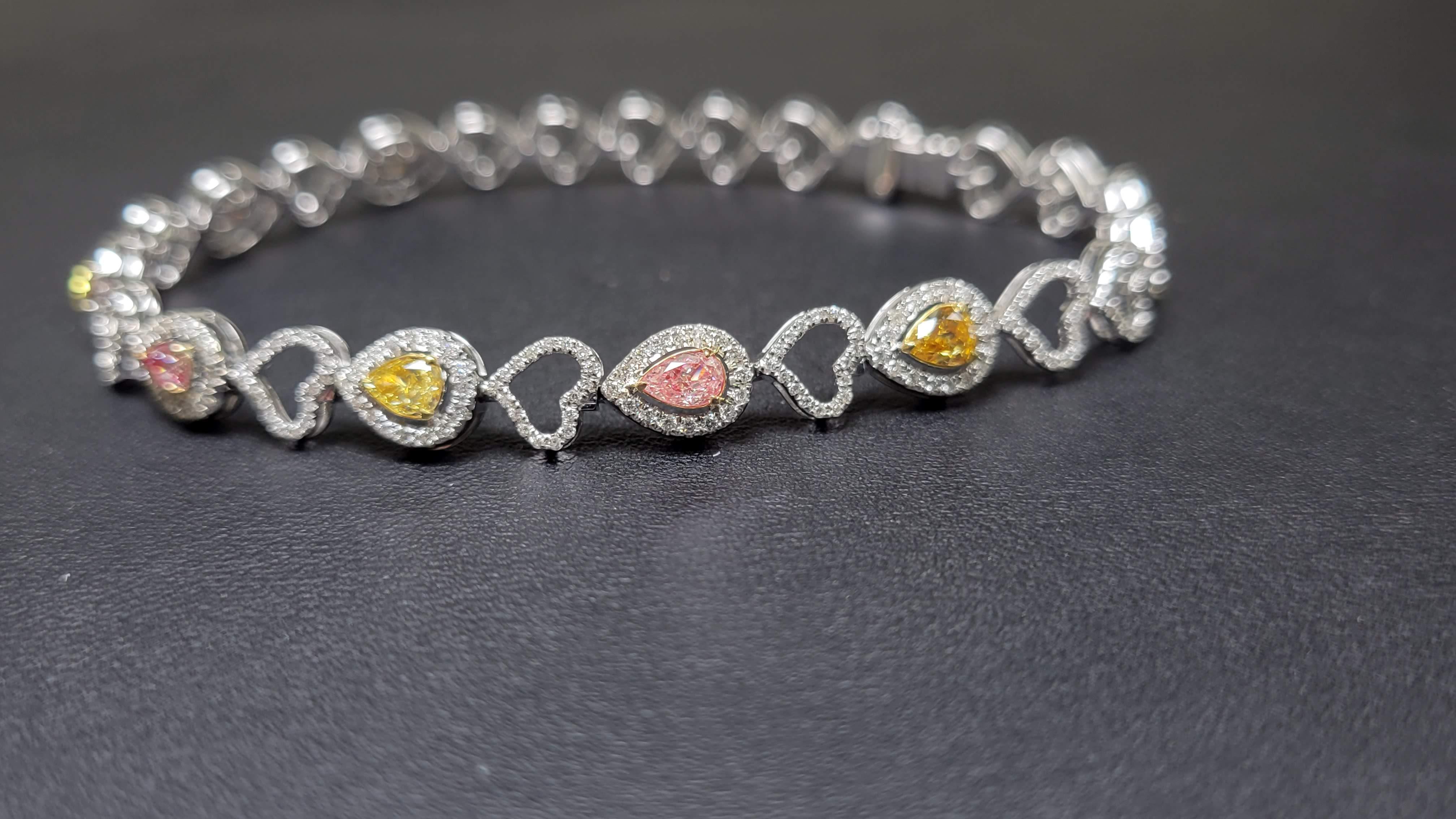 A beautiful array of mix colored and mix shape diamond bracelet mounted in 18K/W  gold, with 1.20cts in Fancy Color Diamonds, and about 1.19cts in White Diamond weight. Diamonds, totaling 2.39cts in weight both color and white diamonds. The