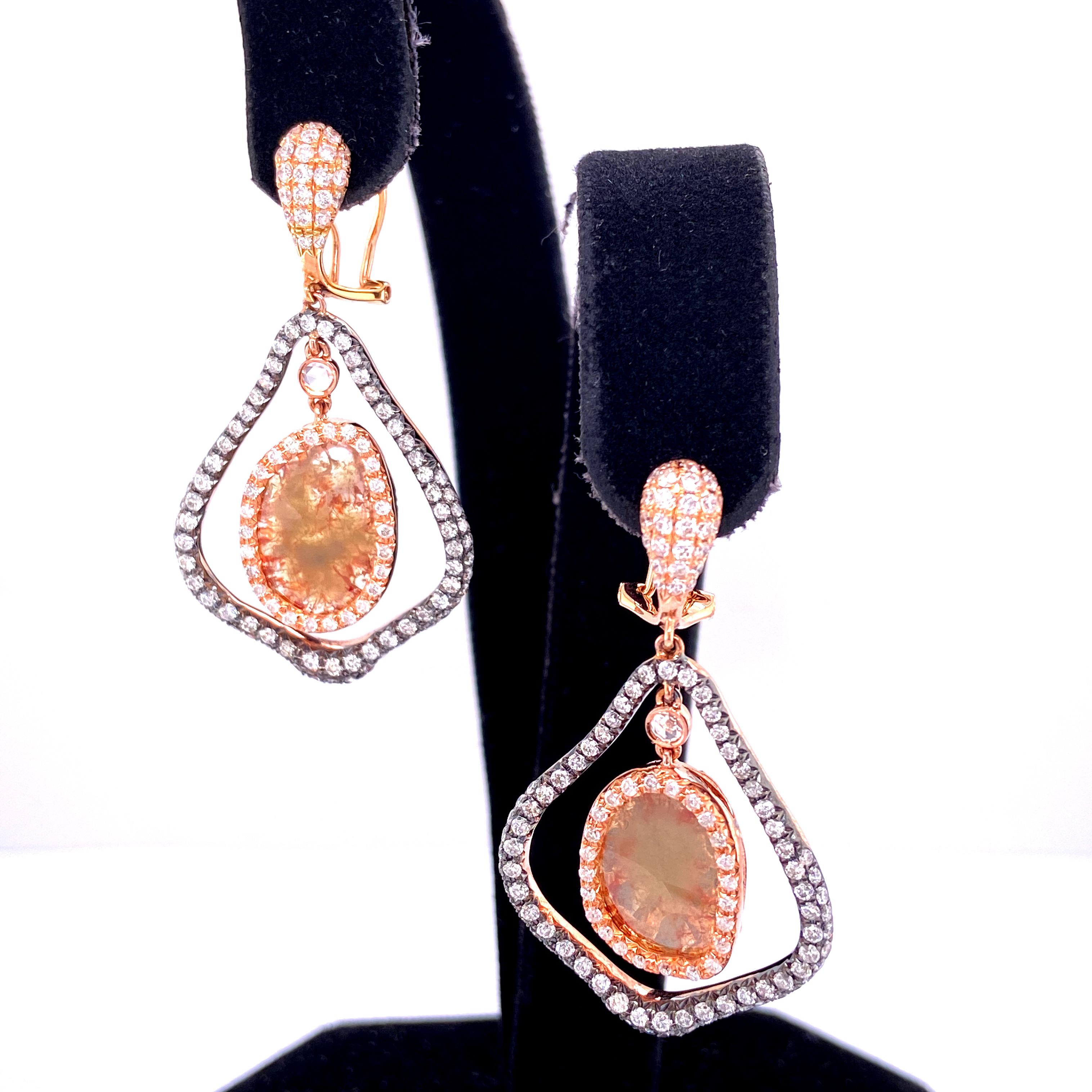Natural Fancy Coloured Diamond and White Diamond Yellow Gold Earrings:

A unique pair of earrings, it features two natural fancy coloured diamond slices weighing 3.04 carat, surrounded by 2.30 carat of white round brilliant diamonds. The fancy