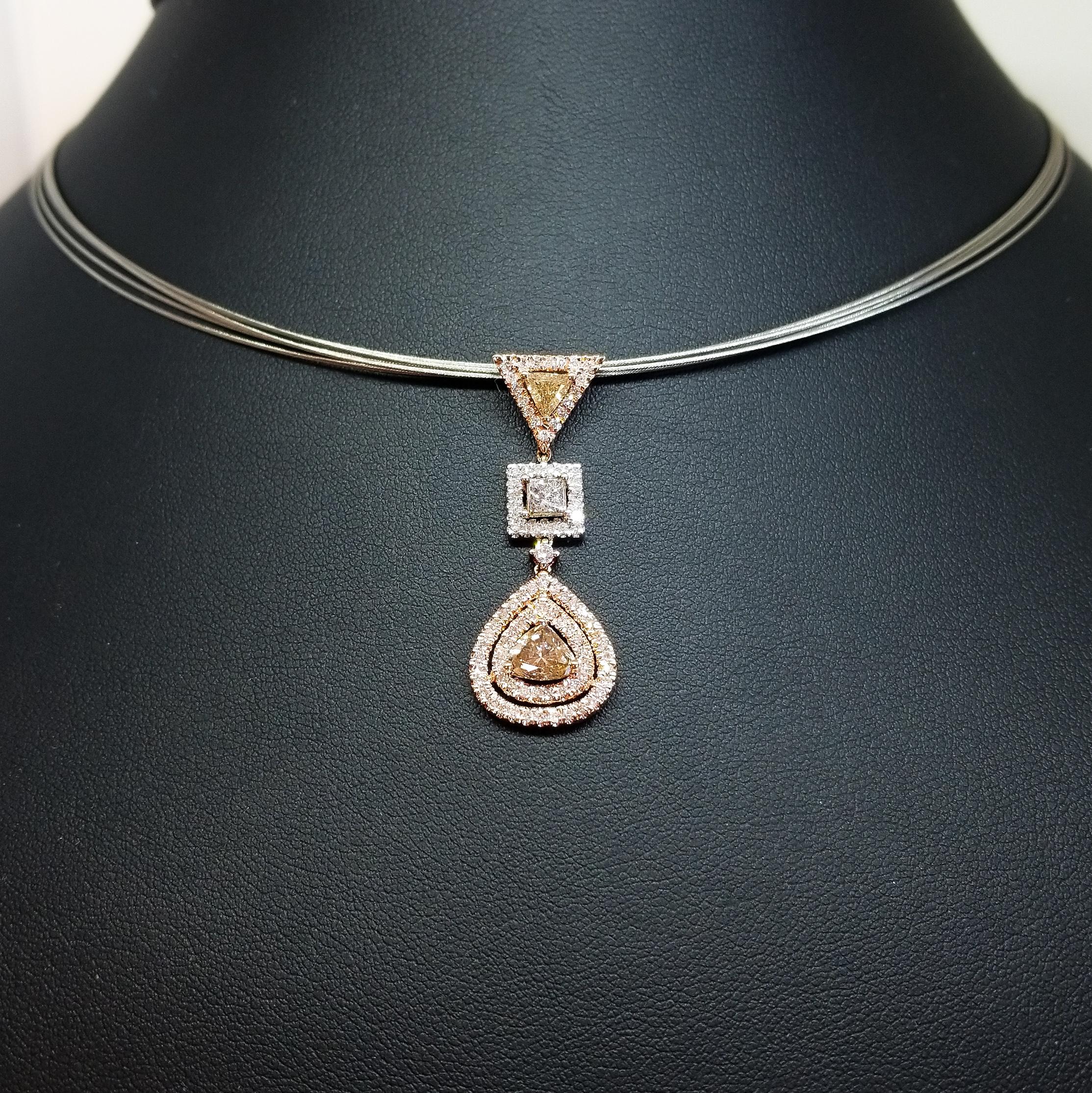 A Retro Contemporary Drop Pendant in 18 Karat Rose and White Gold features Natural Fancy and White Diamonds of 2.10 Carats total weight. The Diamonds are of various sizes and cuts including the larger three Diamonds in the Drop consisting of a 0.33