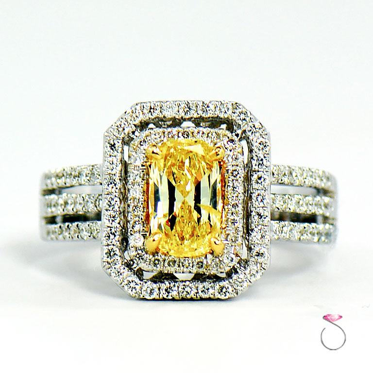 Stunning natural fancy intense yellow diamond ring with white diamond double halo. This magnificent ring features a 1.02 carat cushion shape natural fancy intense yellow Diamond in the center surrounded by white diamond double halo. The 1.02 carat