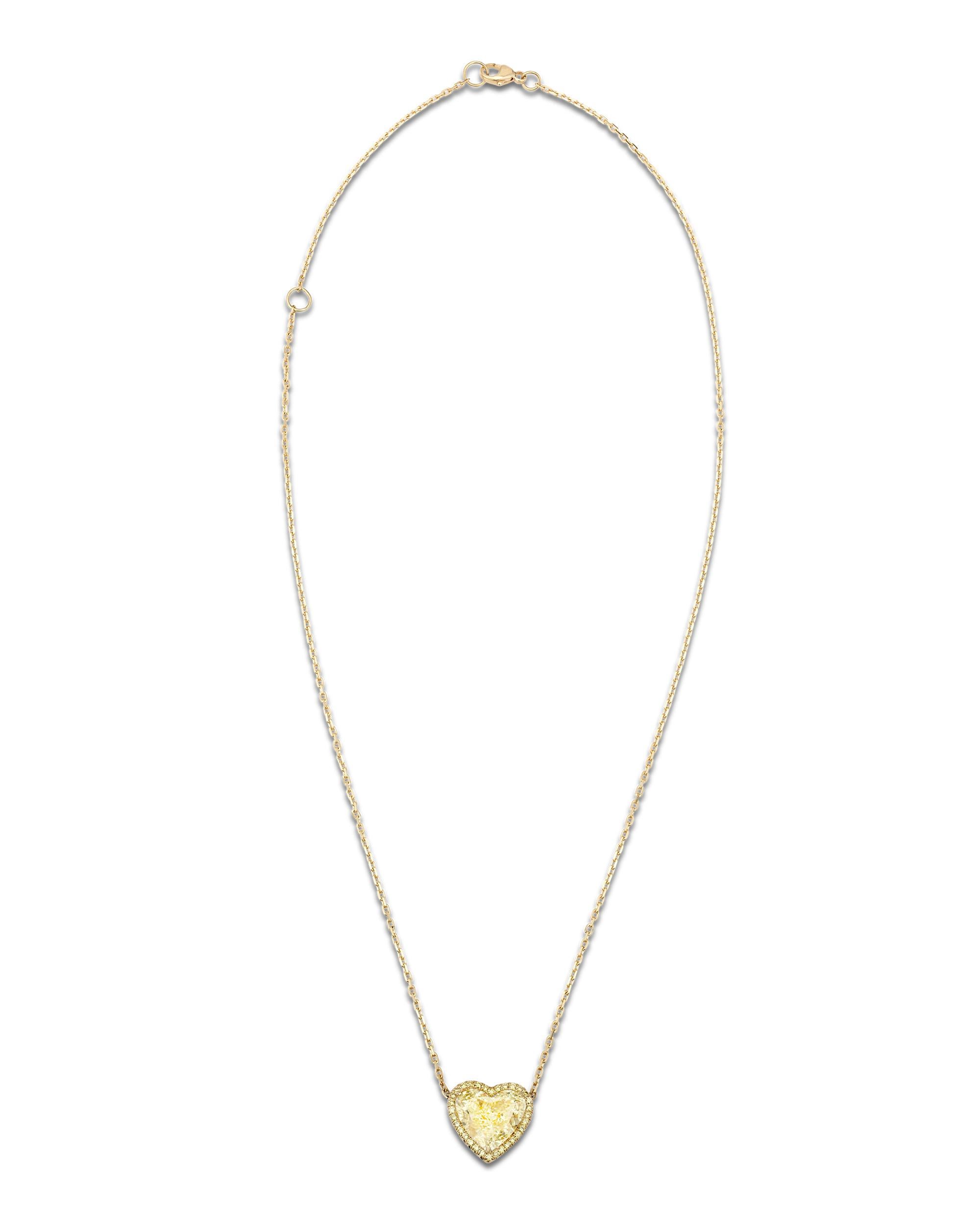 The rarity and beauty of an untreated fancy colored diamond is seldom matched in the realm of precious gemstones. The absolutely dazzling 2.61-carat natural fancy light yellow diamond suspended from this necklace is a spectacular example of these