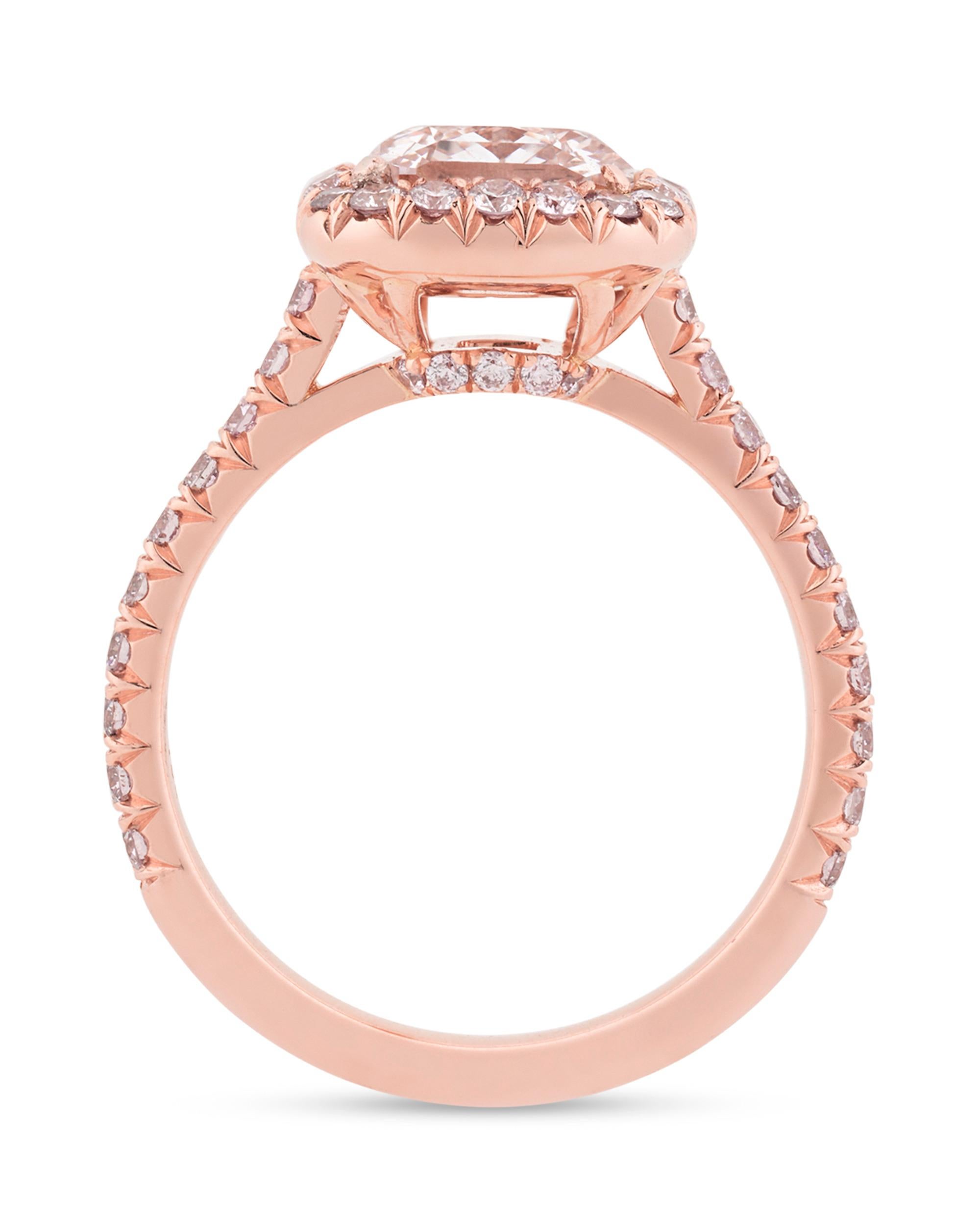 A remarkably rare and beautiful natural fancy pink diamond totaling 2.01 carats centers this breathtaking ring. Mounted in an elegant 18K rose gold setting, approximately 0.65 carats of dazzling light pink pave-cut diamonds accent this stunning
