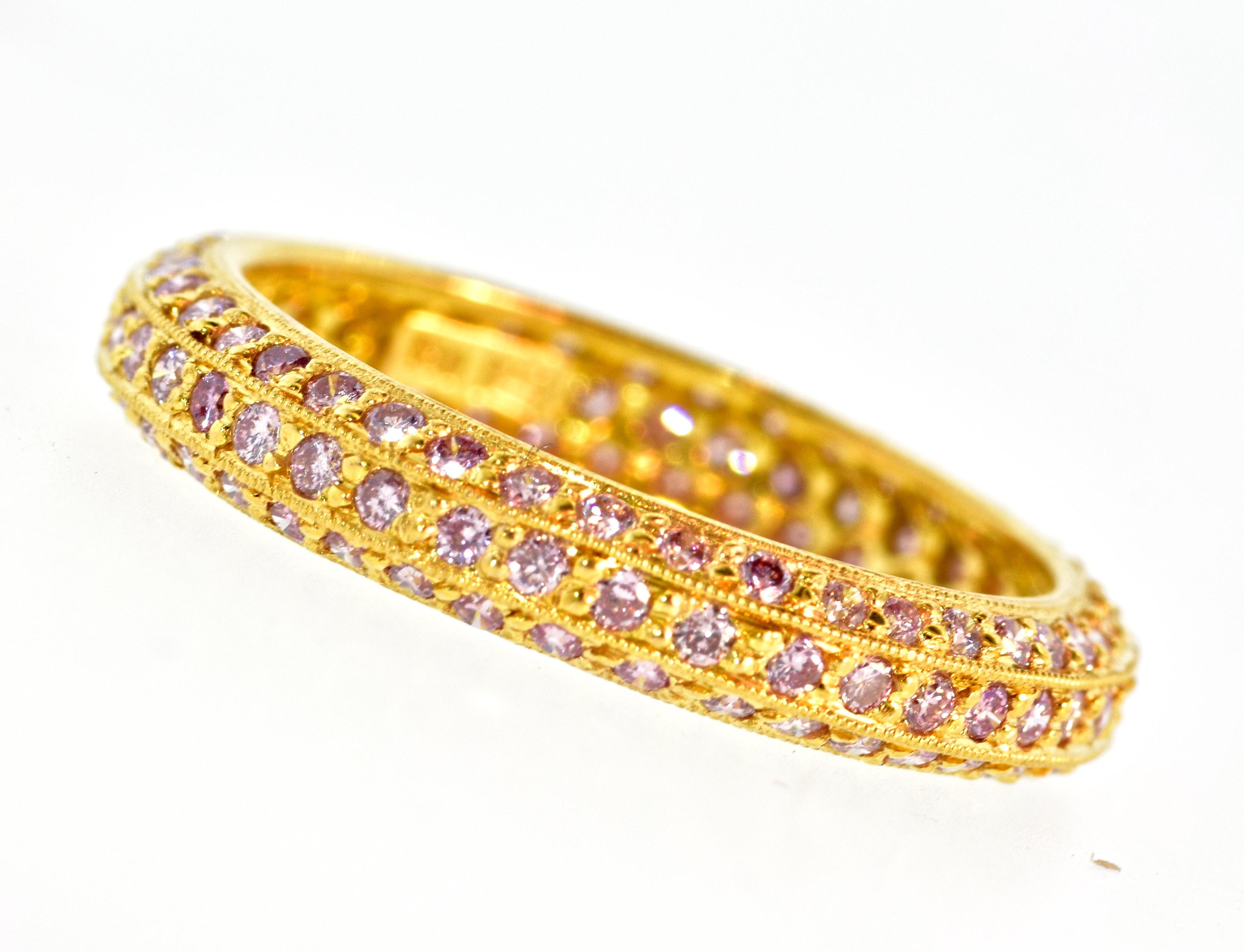Fancy vivid natural pink diamond band  of three rows, with 136 diamonds - all well matched and cut well.  There is estimated to be 1.20 cts  This  new 18K gold band is a size 7.5.  The diamonds display a pretty vivid pink color. The clarity is is