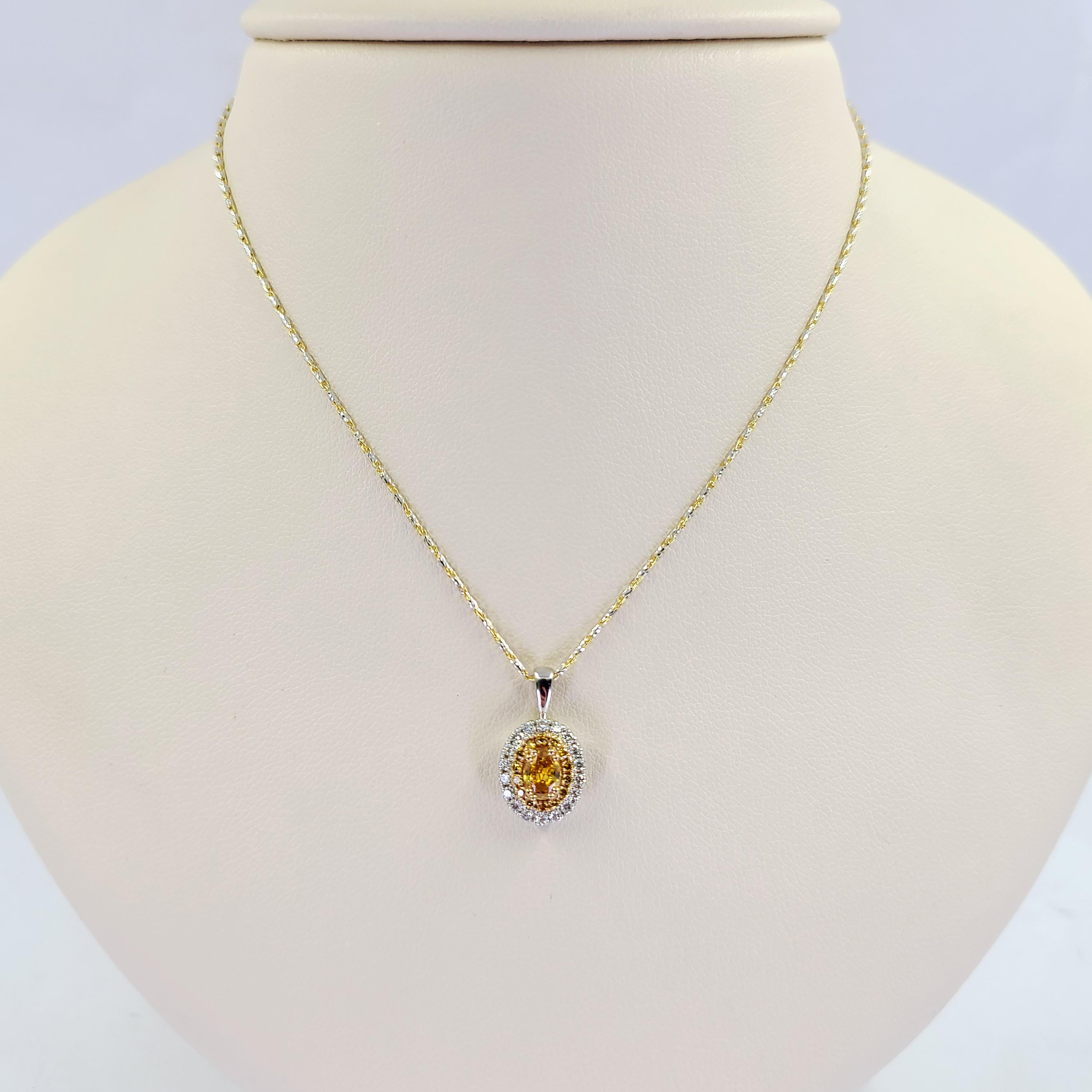 18 Karat White and Yellow Gold Halo Pendant Featuring A 0.37 Carat GIA Graded Fancy Vivid Yellowish Orange Oval Diamond with SI2 Clarity (Report #2196274866) Surrounded By 14 Round Orange Diamonds of SI Clarity Totaling 0.12 Carats, and 18 Round
