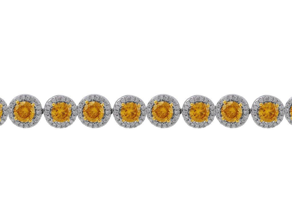 This stunning 18k white gold bracelet is set with 362 round white diamonds and 24 natural fancy to fancy deep yellow diamonds. The white diamonds weigh a total of 1.79cttw and the yellow diamonds, which are GIA-certified, weigh a total of 5.85cttw.