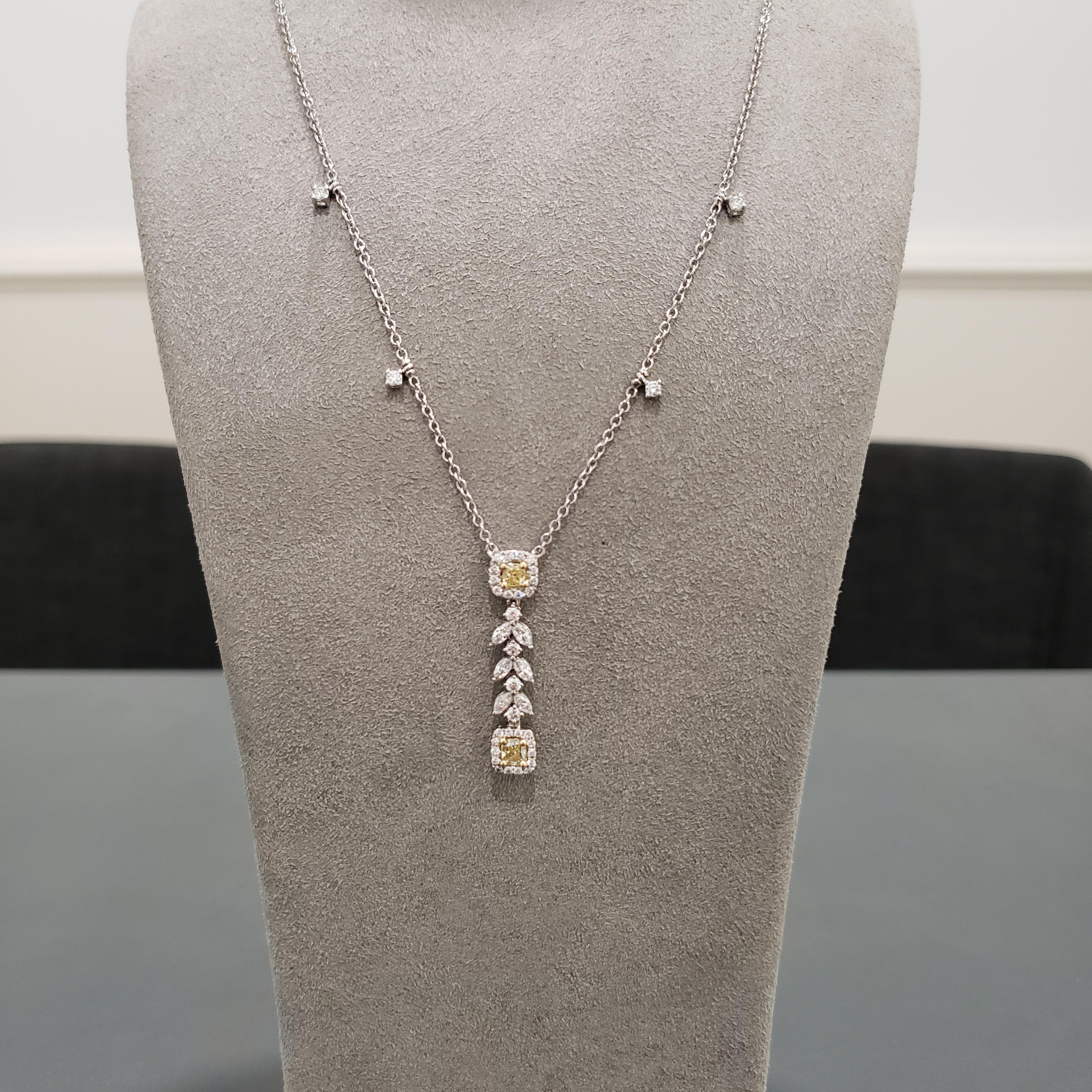 Simple and chic design that accentuates elegance. A gorgeous drop necklace showcasing 2 cushion cut yellow diamonds weighing 0.64 carats total gracefully set in a diamond halo surround. Each cushion diamond is spaced by brilliant marquise and round