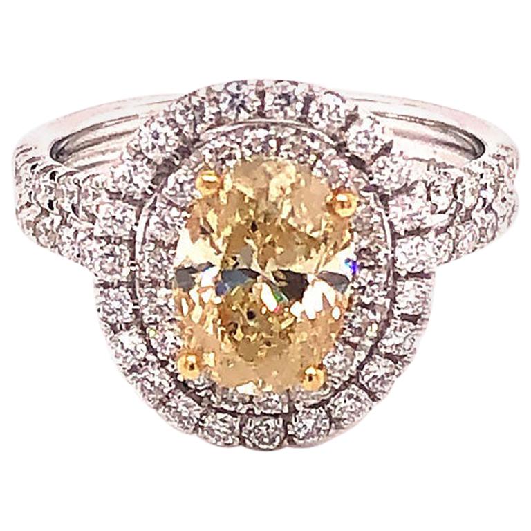 Natural Fancy Yellow Oval Diamond Halo Ring, 1.60 Carat, 18 Karat 2.34 Carat