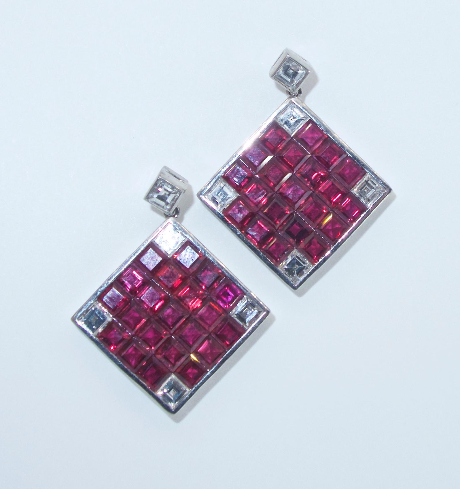 Natural fine rubies displaying a bright red color in a checkerboard like design with square cut diamonds accenting the vibrant rubies and hanging from a matching white square cut diamond.  The 10 well matched and well cut  diamonds are all very