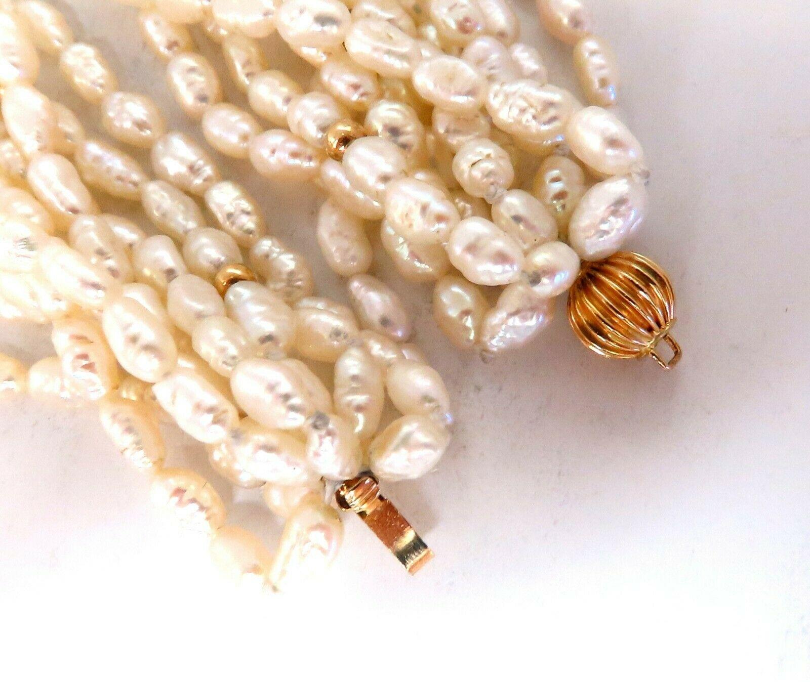10 Stranded Rice / Fresh Water Pearls Necklace.

Off white Light Irish Cream
Necklace: 26 inch long.

14kt Yellow Gold

109.6 Grams.