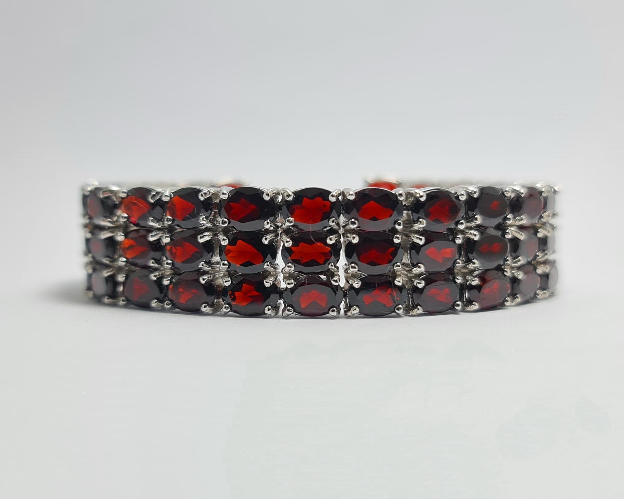 Natural Red Garnet 3 Row Wide Tennis Bracelet set in Pure .925 Sterling Silver with Rhodium Plating

Carat weight: 65 carats
Total bracelet weight: 49 grams