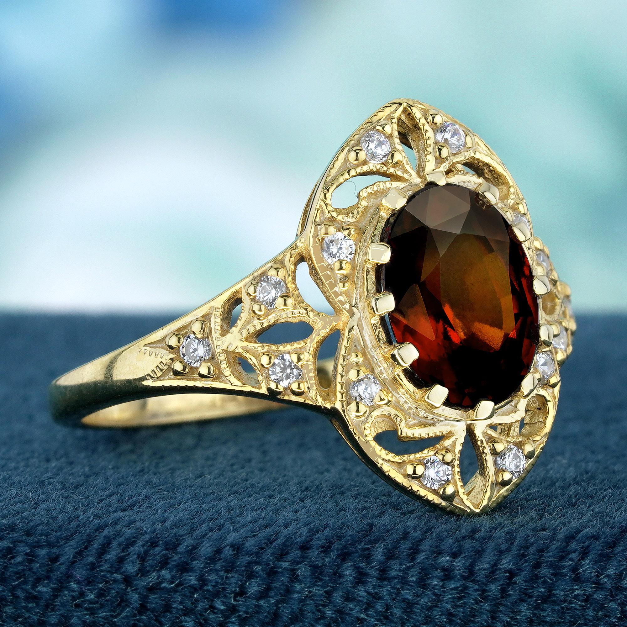 This vintage-inspired ring creates a stunning vintage ensemble. The primary oval-shaped, red natural garnet is the centerpiece, flanked by the sparkle of round natural diamonds Anchored in a charming yellow gold setting that exudes sophistication.