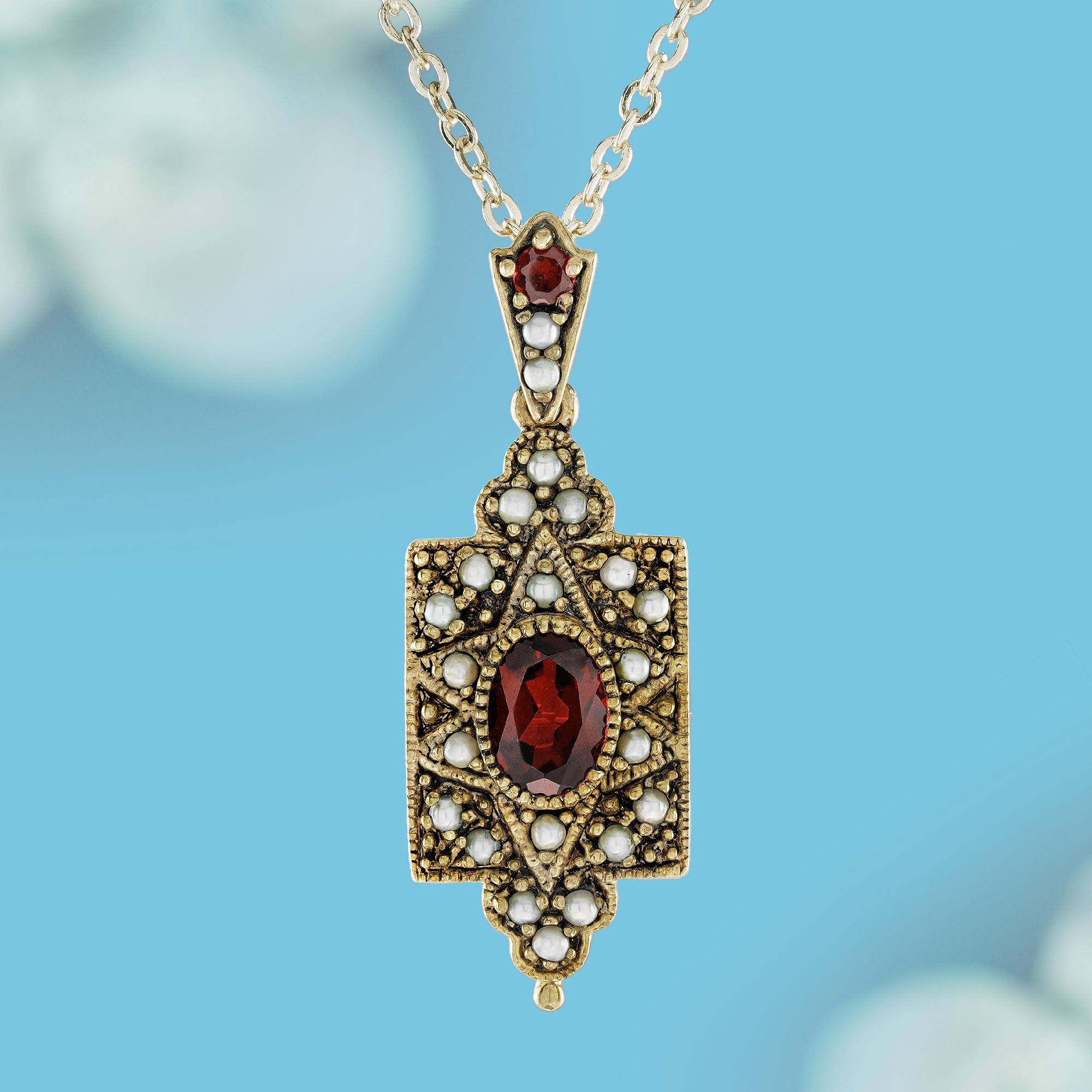 This pendant flaunts a square shape adorned with clusters at both ends, accentuating a round deep red garnet nestled in the center. Enhanced by pearls scattered throughout, it adds a touch of elegance and color to the intricate yellow gold milgrain