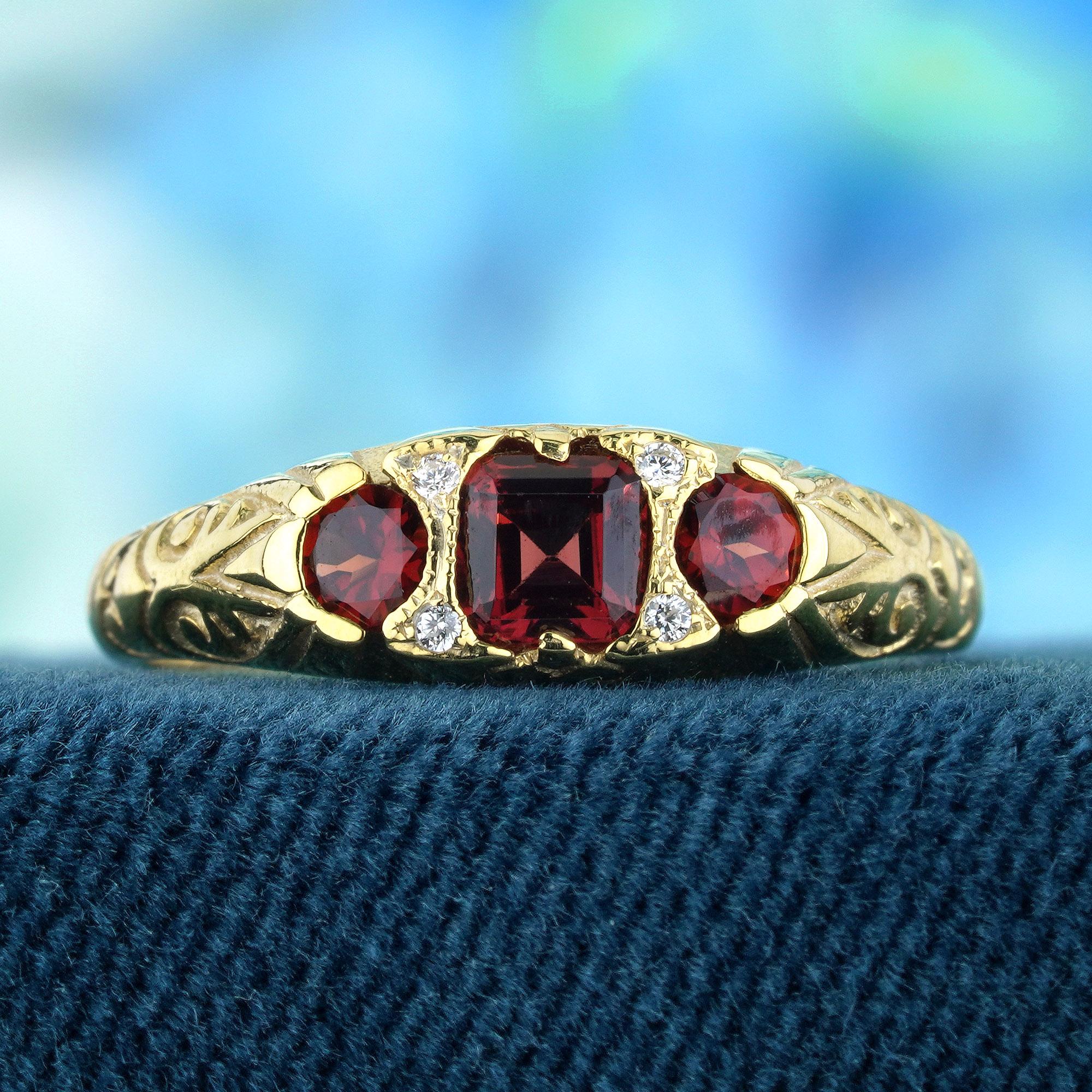 The ring features a vintage style, characterized by intricate carved detailing and a timeless aesthetic. The yellow gold setting offers a warm and rich backdrop for the gemstones. At the heart of the ring are three natural vibrant red garnets.