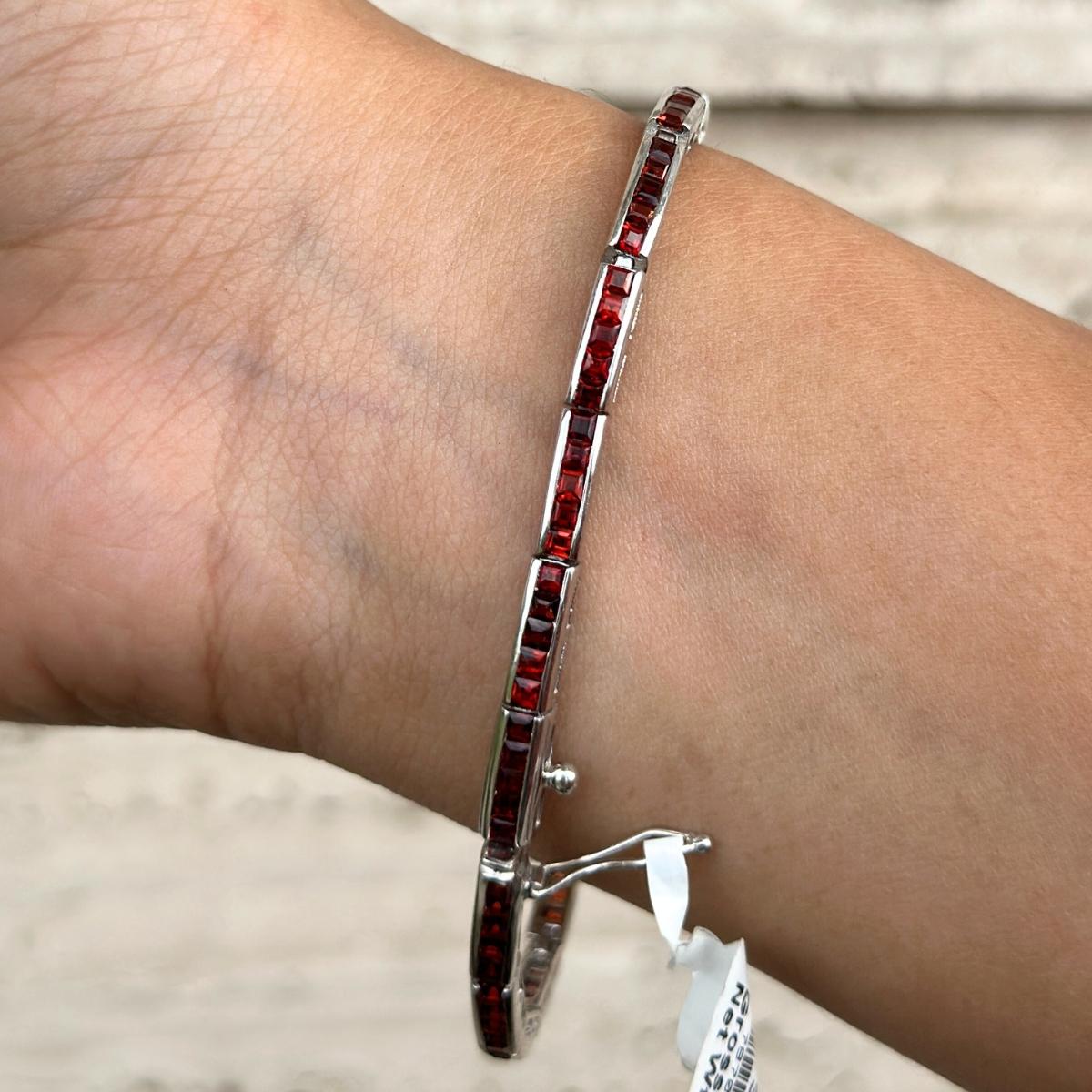 Natural Garnet Tennis Bracelet in sterling silver showcases endlessly sparkling natural garnet, weighing 4.98 carat. It measures 7 inches long in length. 
Garnet stimulate concentration and reduces stress. 
Designed with perfect square cut garnet