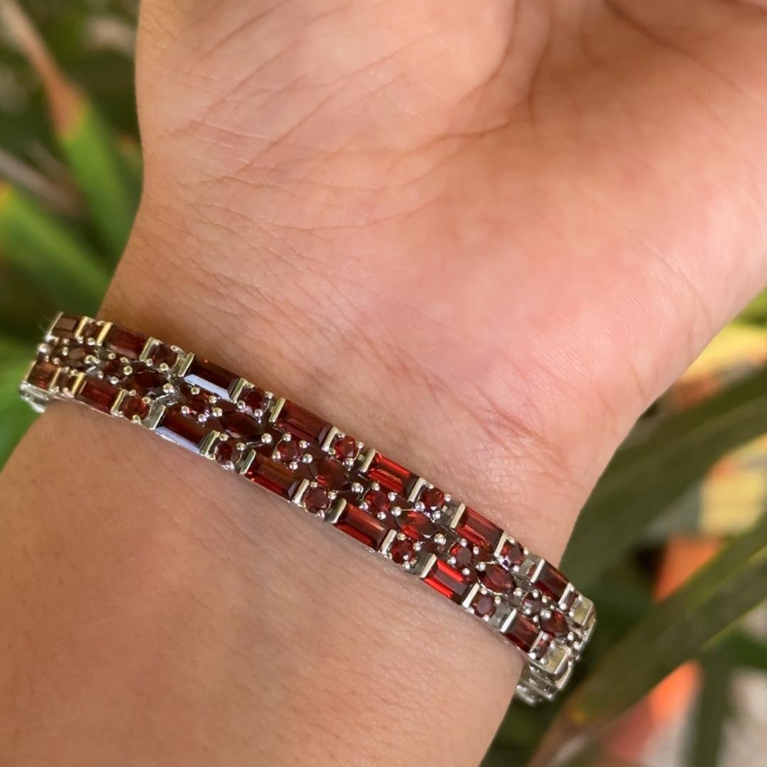 Natural Garnet Triple Row Stone 18.1 Carat Tennis Bracelet in Sterling Silver for Women in sterling silver showcases endlessly sparkling natural garnet, weighing 18.1 carat. It measures 7 inches long in length.
Garnet stimulate concentration and