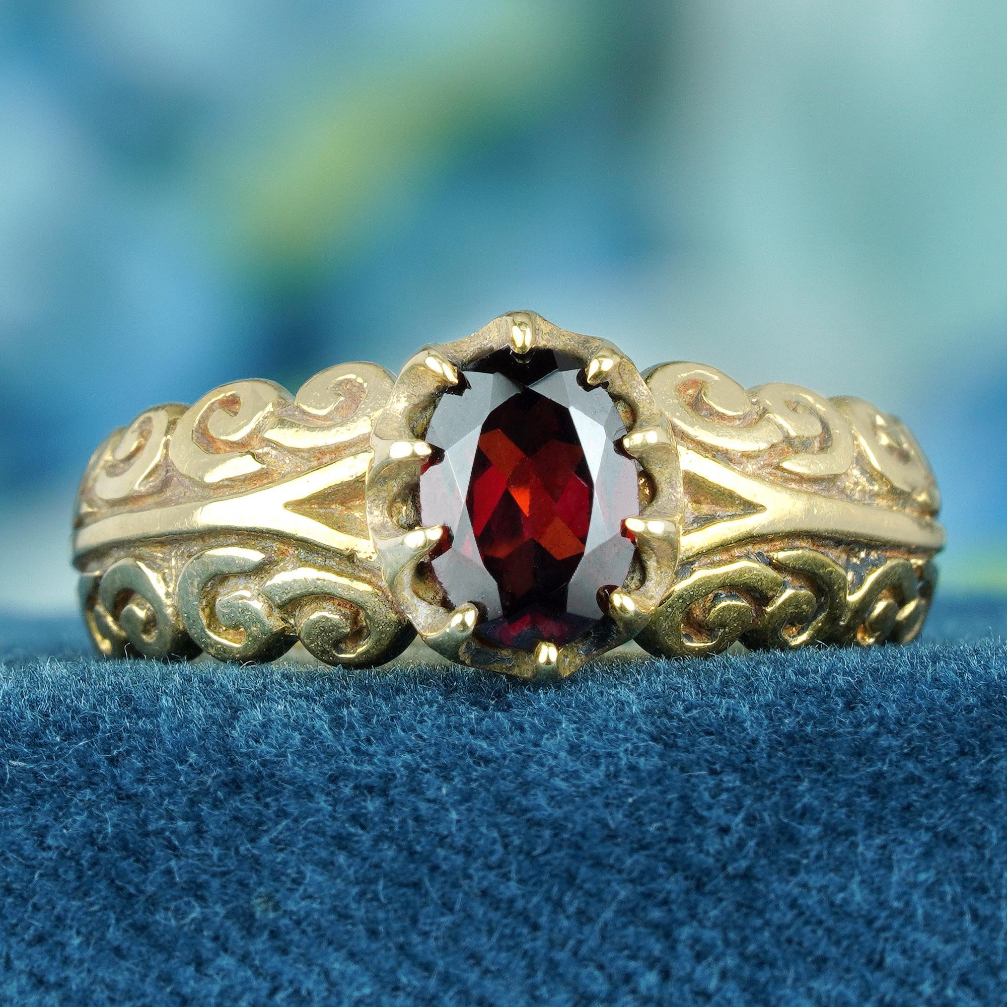 Adorned with a fiery oval red garnet gemstone and set in intricate gold, this ring stands as a masterpiece of craftsmanship. The delicate swirling carved band speaks volumes about artistry and meticulous attention to detail. So, go ahead, indulge in