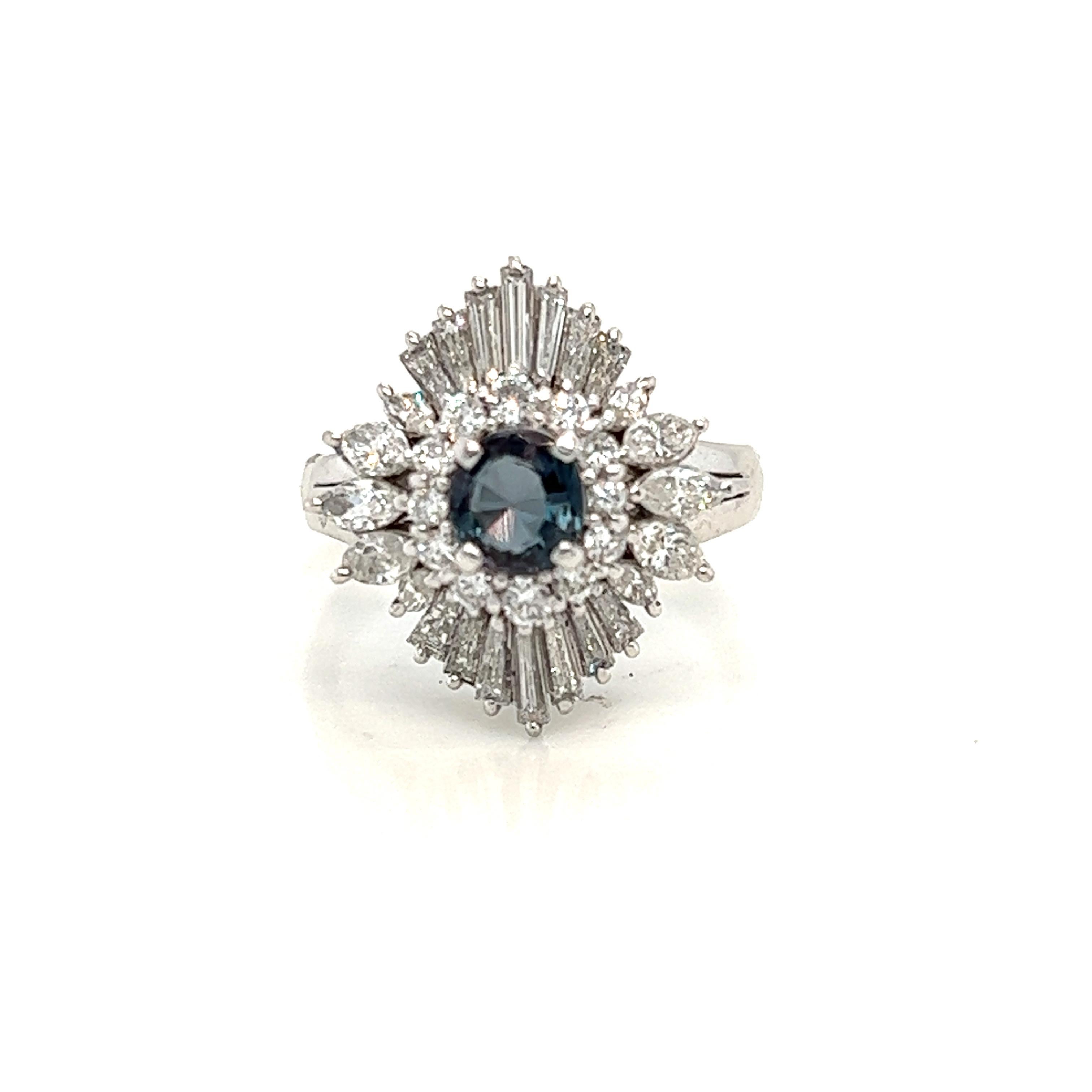 This is a gorgeous natural AAA quality Oval Alexandrite surrounded by dainty diamonds that is set in a cocktail platinum setting. This ring features a natural 0.61 carat oval alexandrite that is certified by the Gemological Institute of America