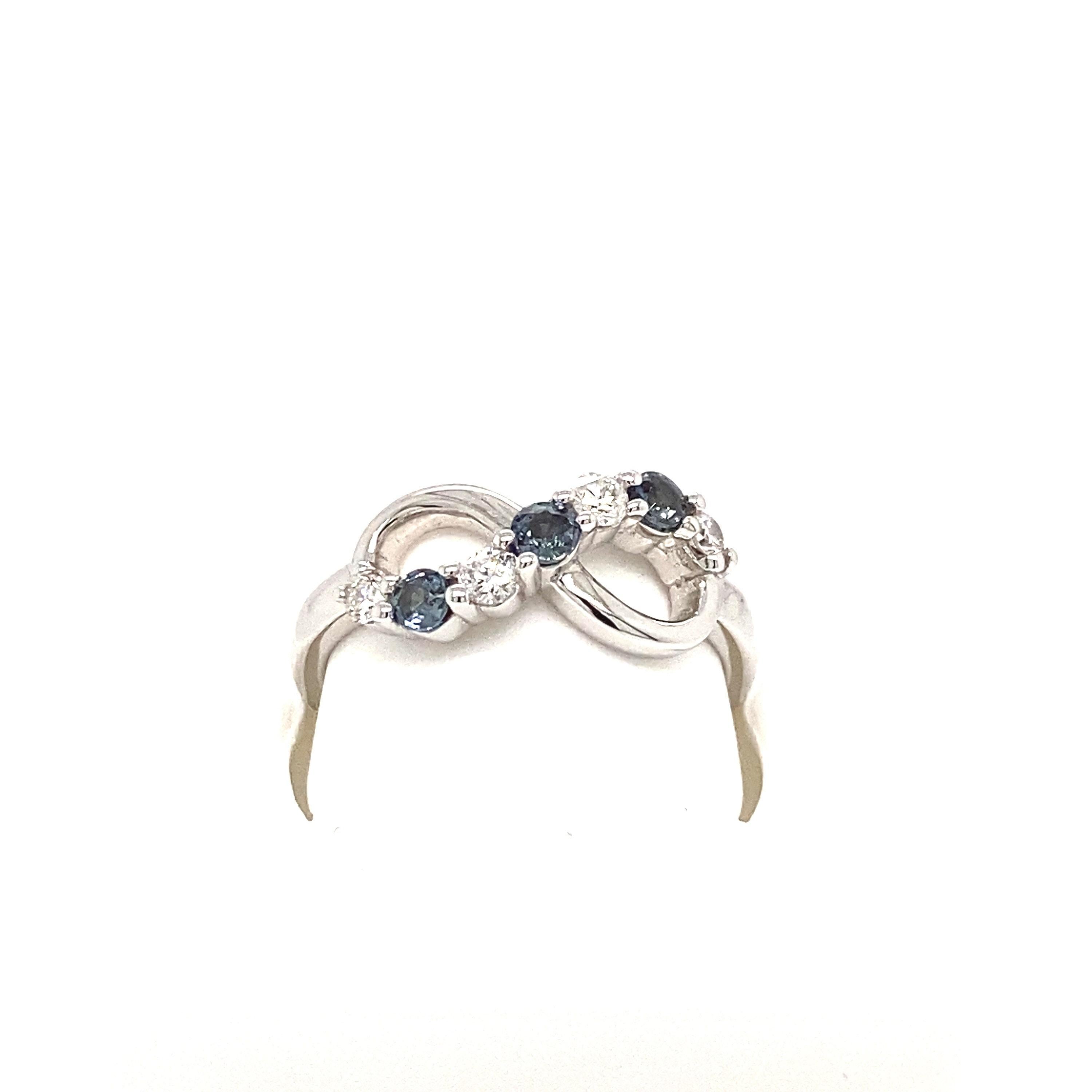 This is a gorgeous natural AAA quality round Alexandrite(s) surrounded by dainty diamonds that are set in a vintage white gold setting. This ring features  natural 0.25 carat round alexandrites that are certified by the Gemological Institute of