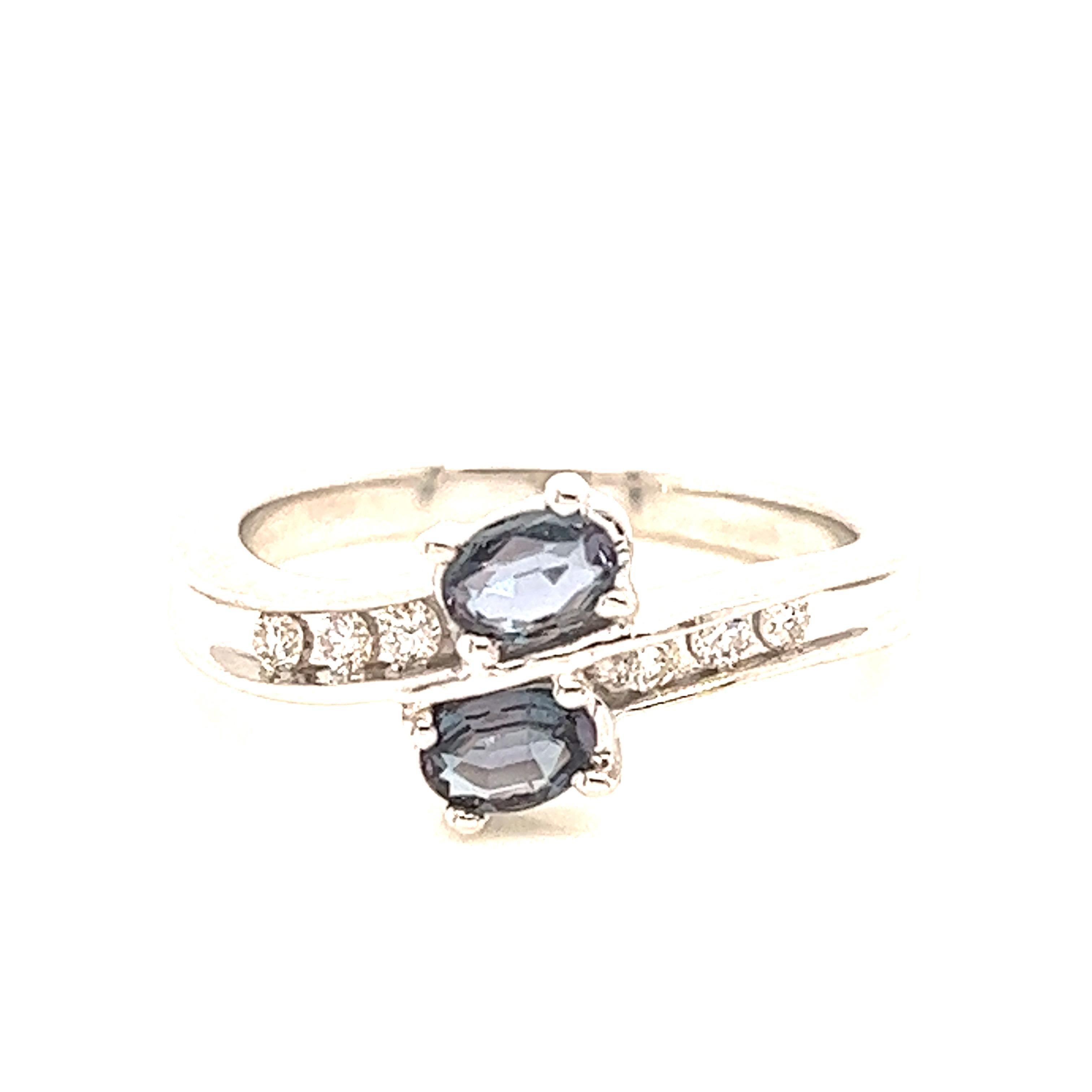 This is a gorgeous natural AAA quality oval Alexandrite surrounded by dainty diamonds that is set in a vintage white gold setting. This ring features a natural 0.35 oval alexandrite that is surrounded by brilliant white diamonds. The ring is a true