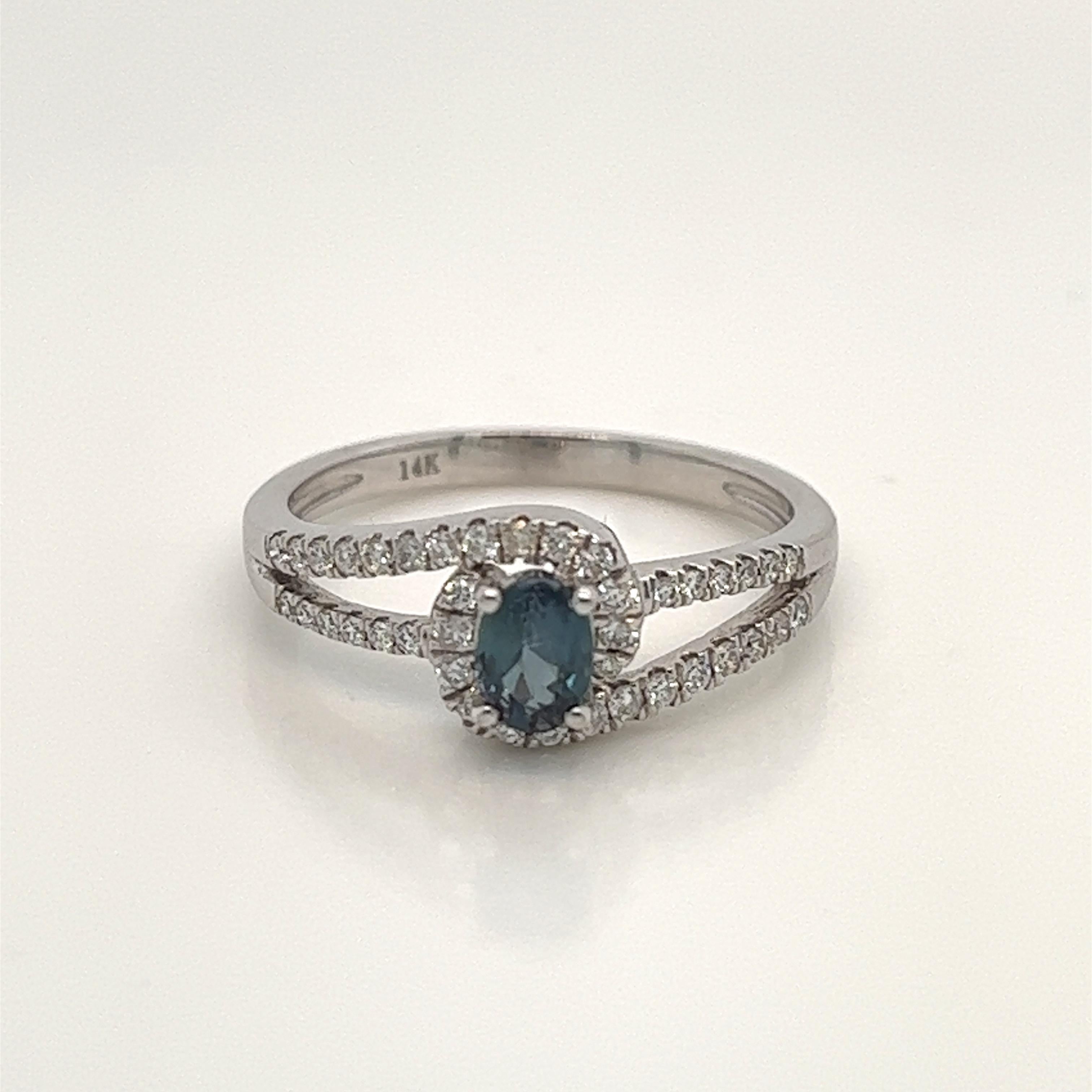 This is a gorgeous natural AAA quality oval Alexandrite surrounded by dainty diamonds that is set in solid 14K white gold. This ring features a natural 0.45carat oval alexandrite that is certified by the Gemological Institute of America (GIA). The