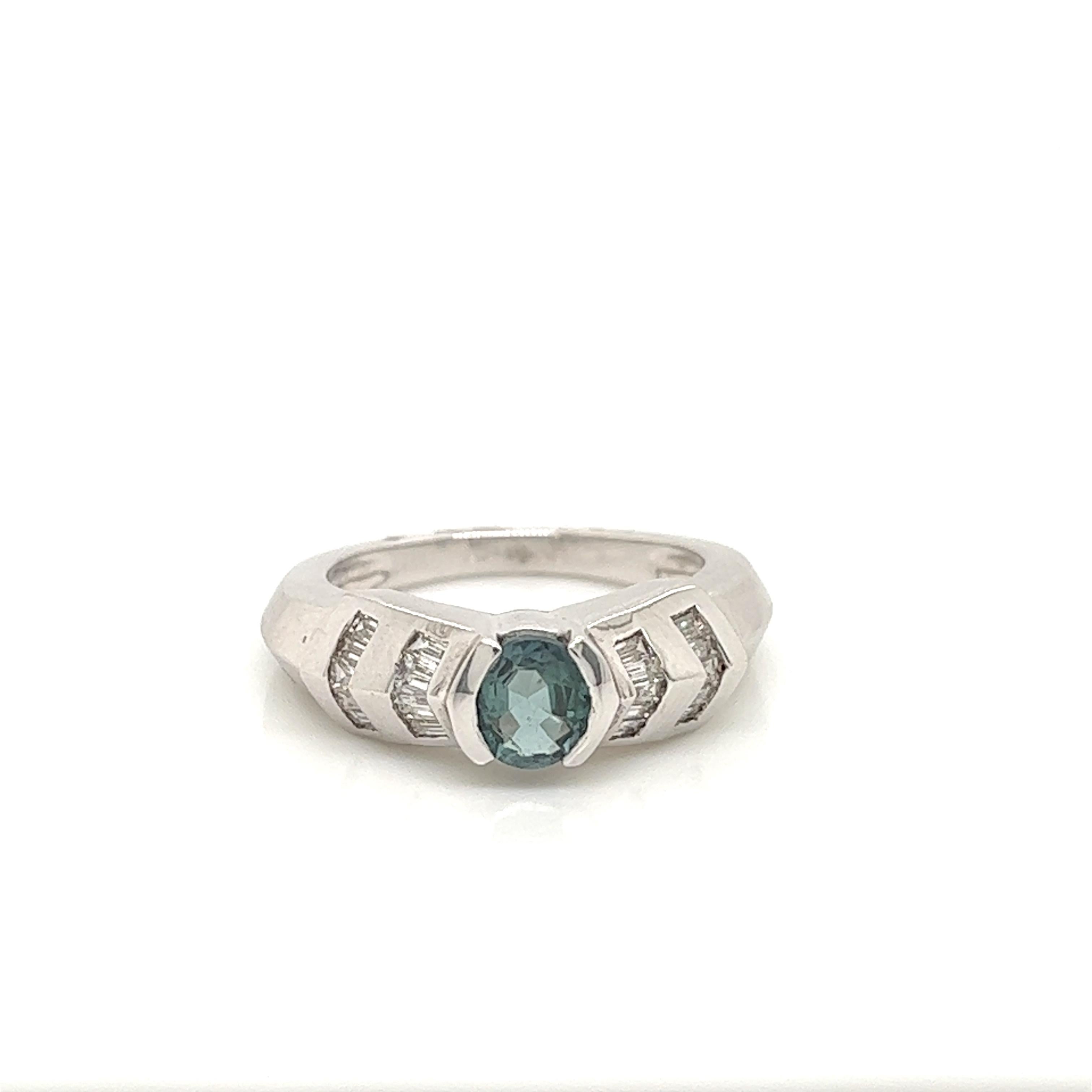 This is a gorgeous natural AAA quality Oval Alexandrite with Baguette diamonds that is set in solid 18K white gold. This ring features a natural 0.66 carat oval alexandrite that is certified by the Gemological Institute of America (GIA). The ring is