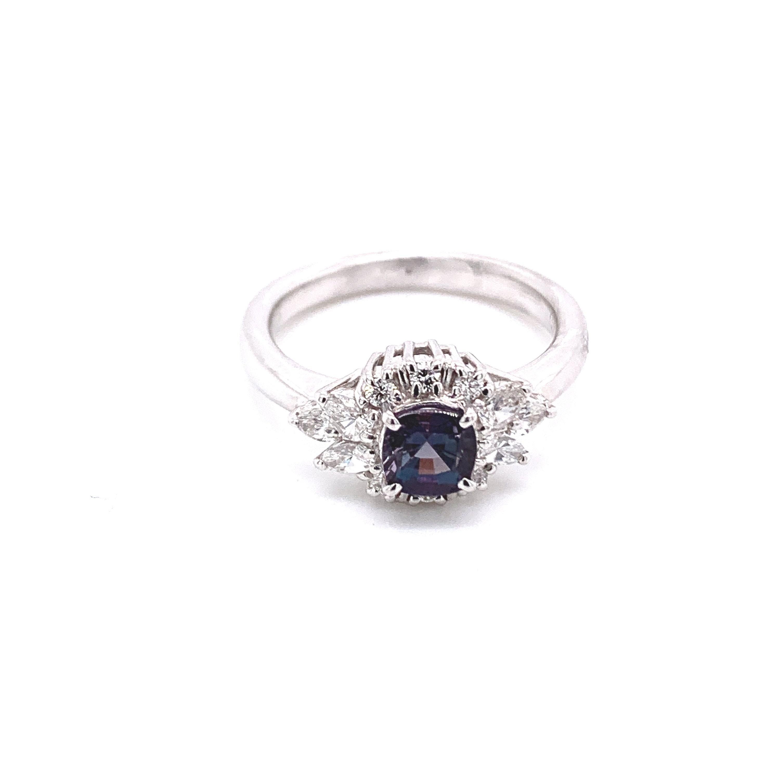 This is a gorgeous natural AAA quality cushion Alexandrite surrounded by a dainty diamond halo that is set in a vintage platinum setting. This ring features a natural 0.68 alexandrite that is certified by the Gemological Institute of America (GIA)