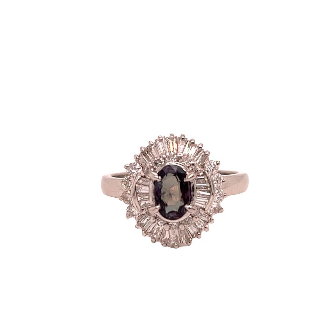 This is a gorgeous natural AAA quality oval Alexandrite surrounded by dainty diamonds that are set in a vintage platinum setting. This ring features a natural 0.75 oval alexandrite that is certified by the Gemological Institute of America (GIA) and