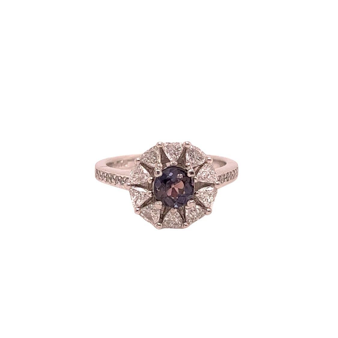 This is a gorgeous natural AAA quality round Alexandrite surrounded by a dainty diamond halo that is set in a vintage platinum setting. This ring features a  natural 0.76 round alexandrite that is certified by the Gemological Institute of America