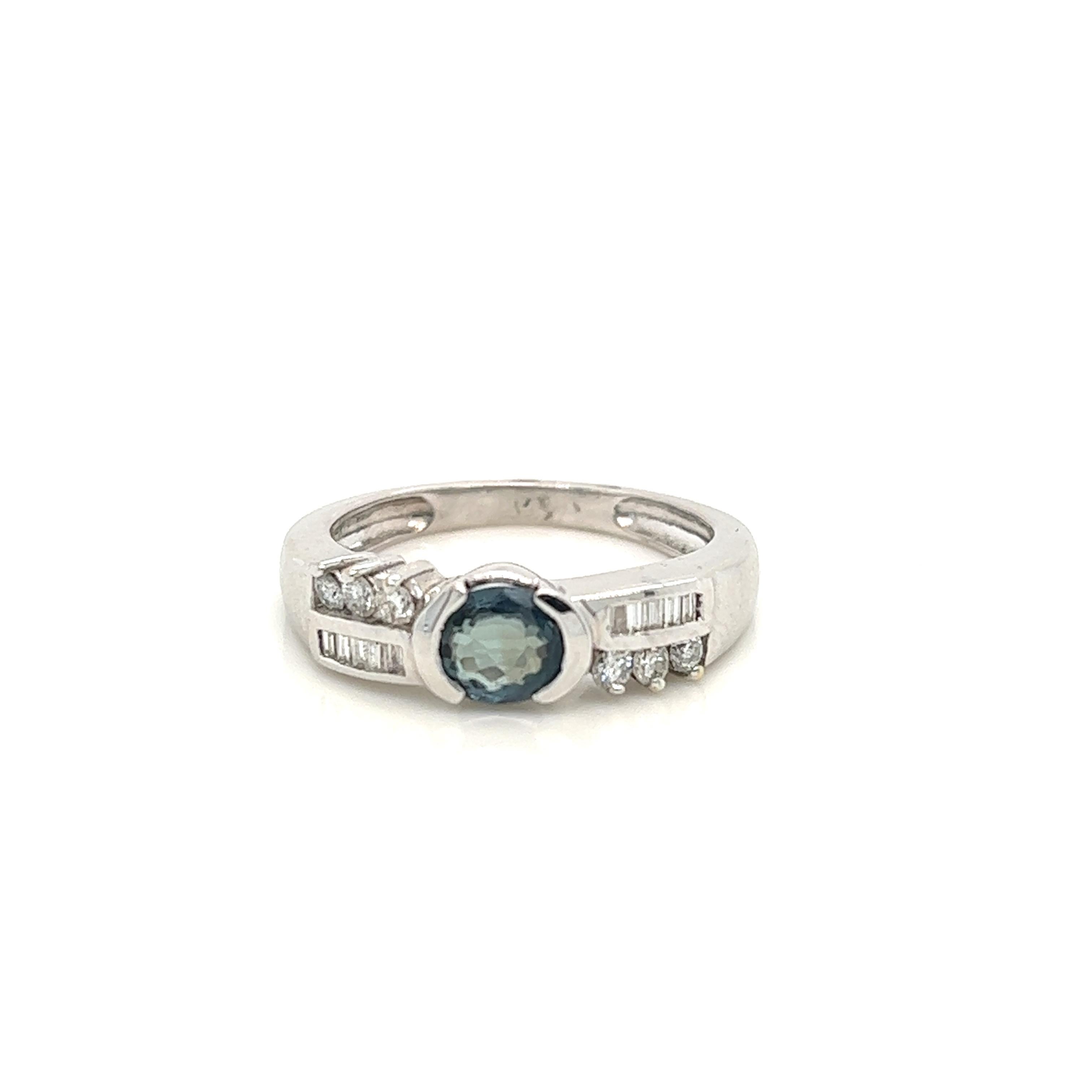 This is a gorgeous natural AAA quality Oval Alexandrite with Baguette diamonds that is set in solid 18K white gold. This ring features a natural 0.81 carat oval alexandrite that is certified by the Gemological Institute of America (GIA). The ring is
