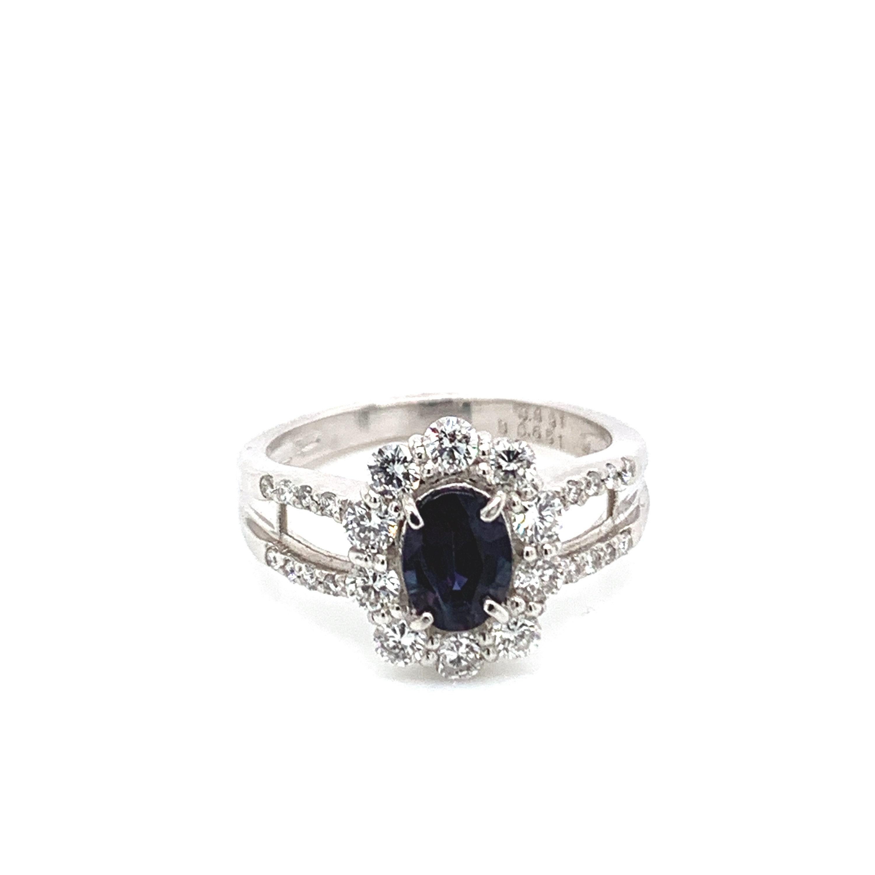 This is a gorgeous natural AAA quality oval Alexandrite surrounded by a dainty diamond halo that is set in a vintage platinum setting. This ring features a  natural 0.85 OVAL alexandrite that is certified by the Gemological Institute of America