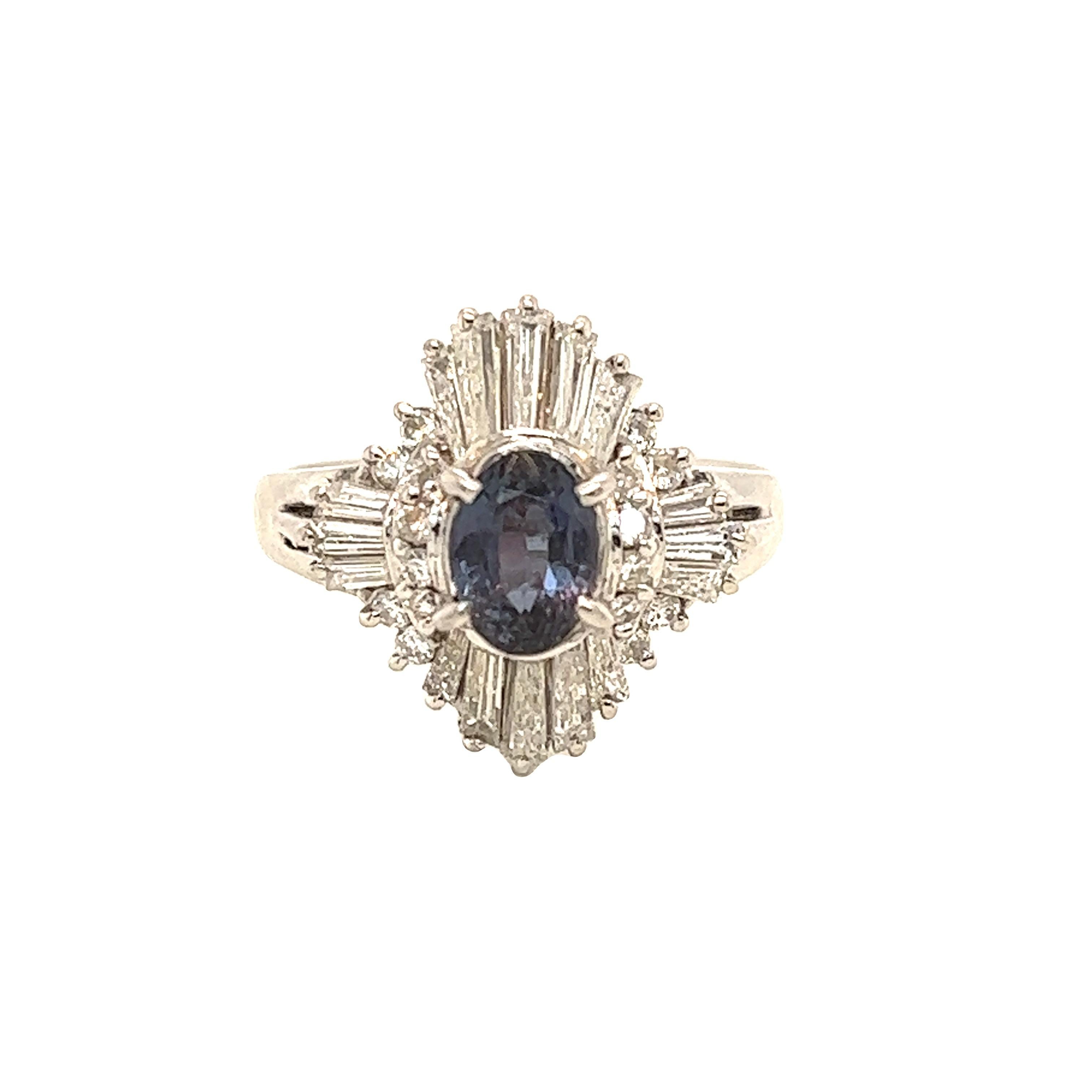 This is a gorgeous natural AAA quality oval Alexandrite surrounded by dainty diamonds that is set in a vintage Platinum setting. This ring features a natural 0.86 carat oval alexandrite that is certified by the Gemological Institute of America (GIA)