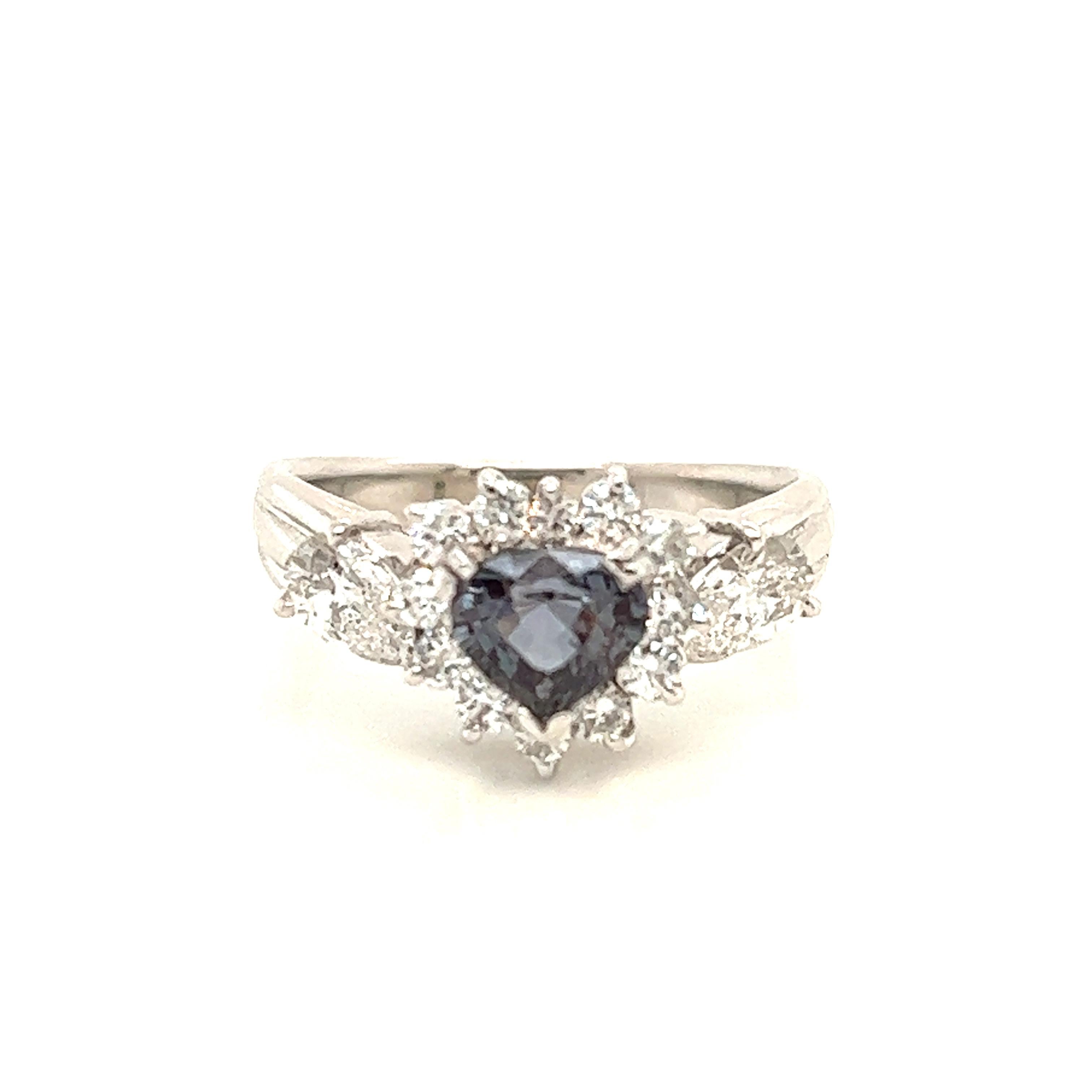 This is a gorgeous natural AAA quality heart Alexandrite surrounded by dainty diamonds that is set in a vintage platinum setting. This ring features a natural 0.87carat heart alexandrite that is certified by the Gemological Institute of America