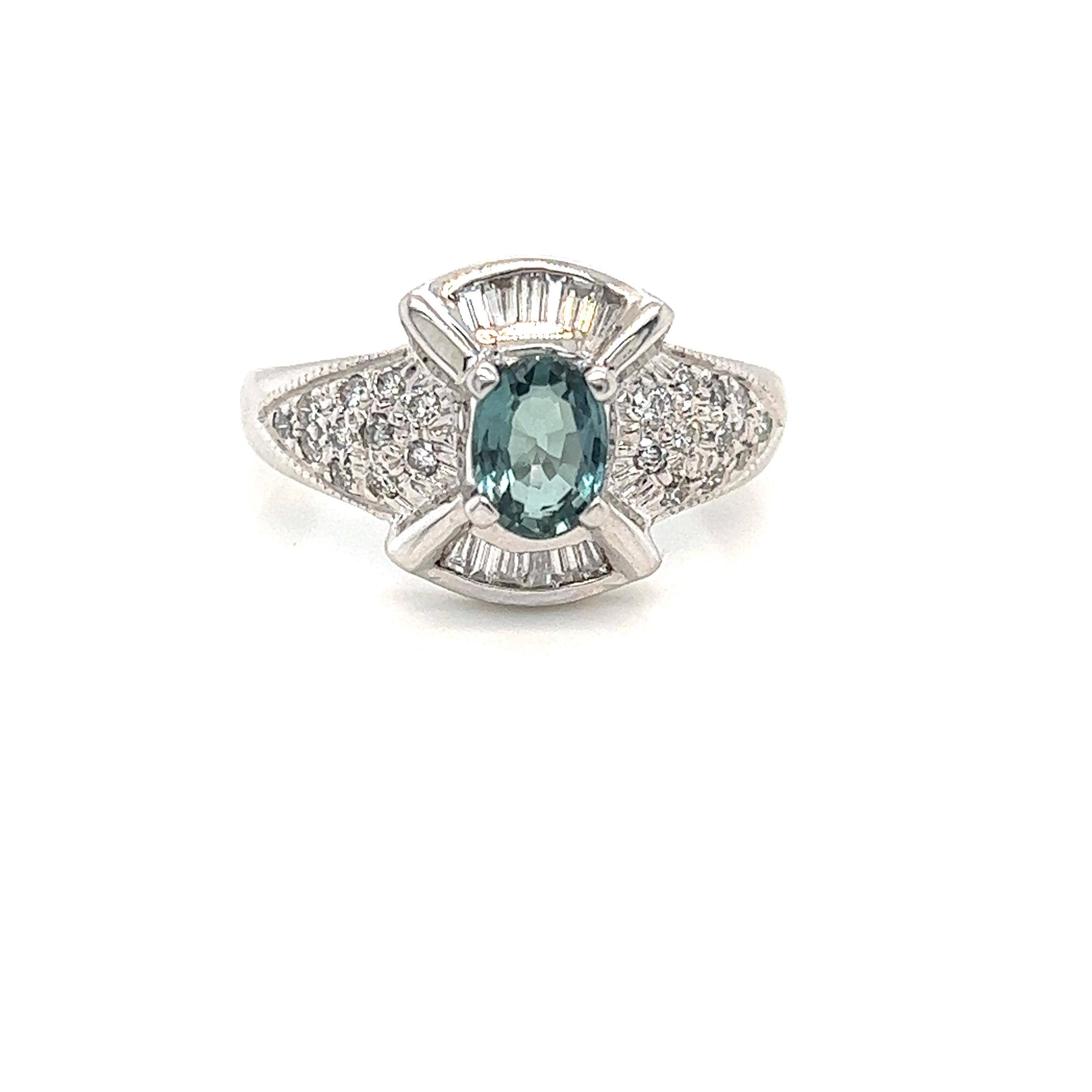 This is a gorgeous natural AAA quality Oval Alexandrite with Baguette diamonds that is set in solid 18K white gold. This ring features a natural 0.88 carat oval alexandrite that is certified by the Gemological Institute of America (GIA). The ring is