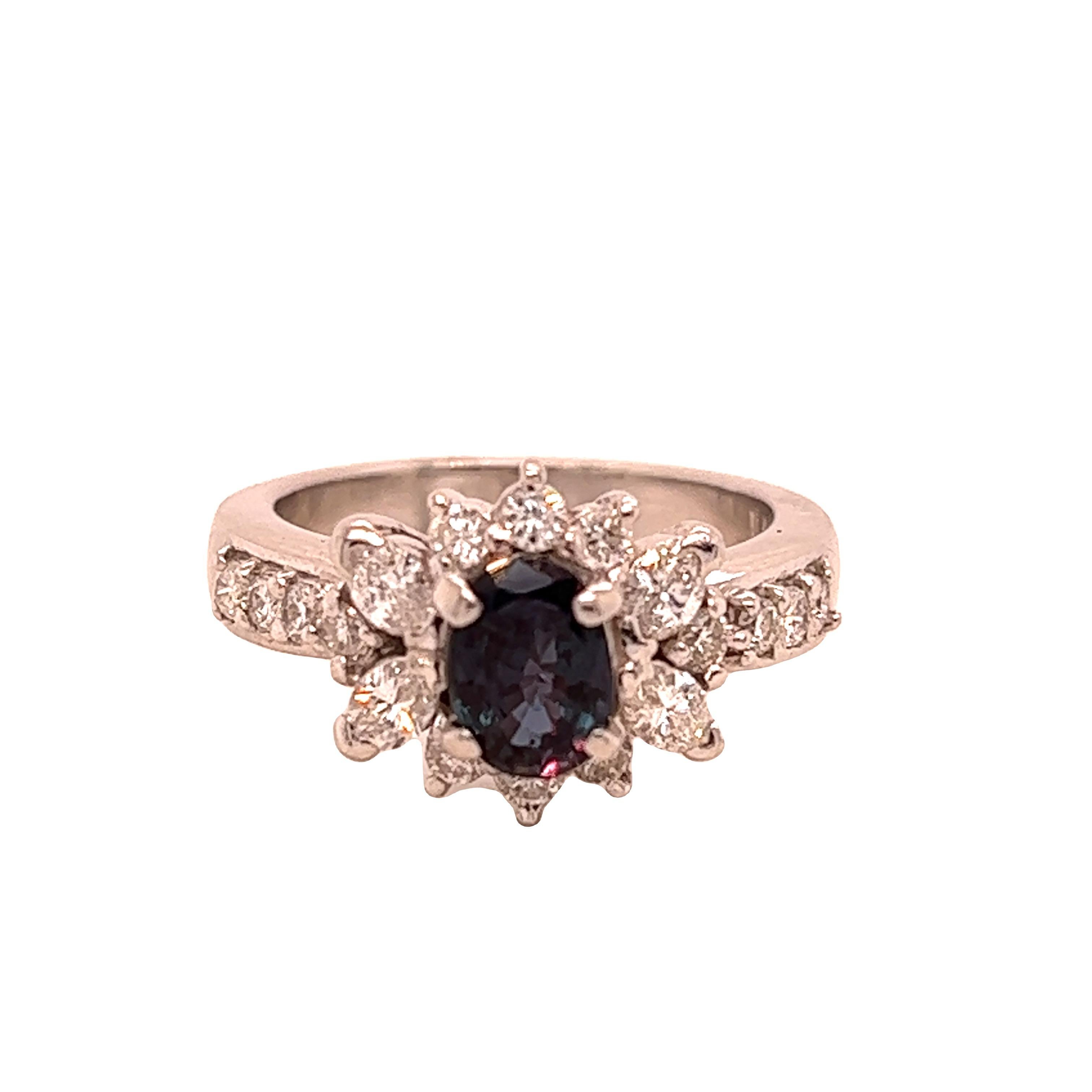 This is a gorgeous natural AAA quality oval Alexandrite surrounded by dainty diamonds that is set in a vintage platinum setting. This ring features a natural 0.89 carat oval alexandrite that is certified by the Gemological Institute of America (GIA)