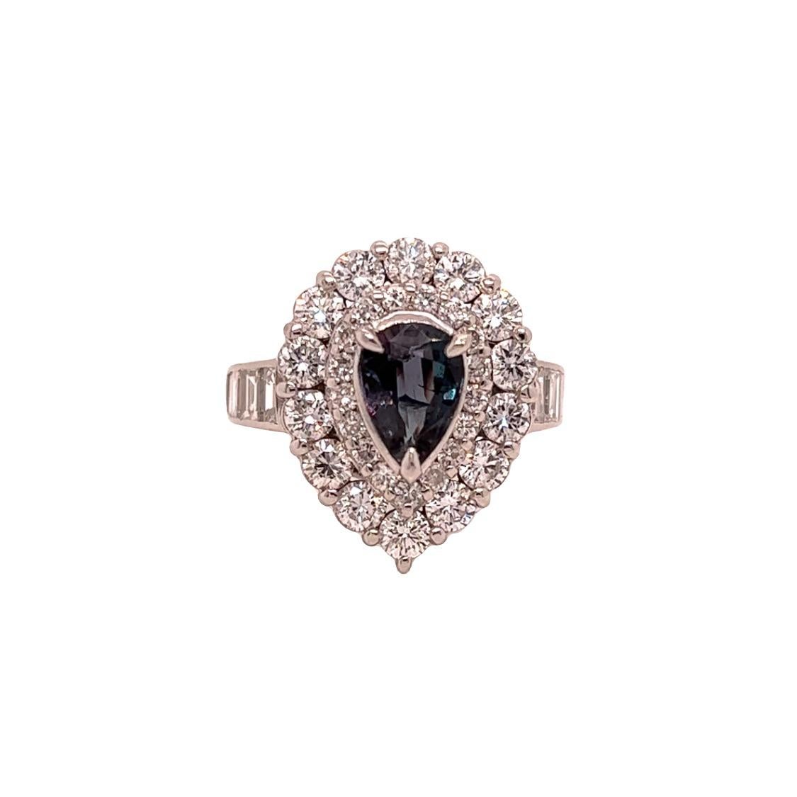 This is a gorgeous natural AAA quality pear shaped Alexandrite surrounded by a dainty diamond halo that is set in a vintage platinum setting. This ring features a natural 0.99 pear alexandrite that is certified by the Gemological Institute of