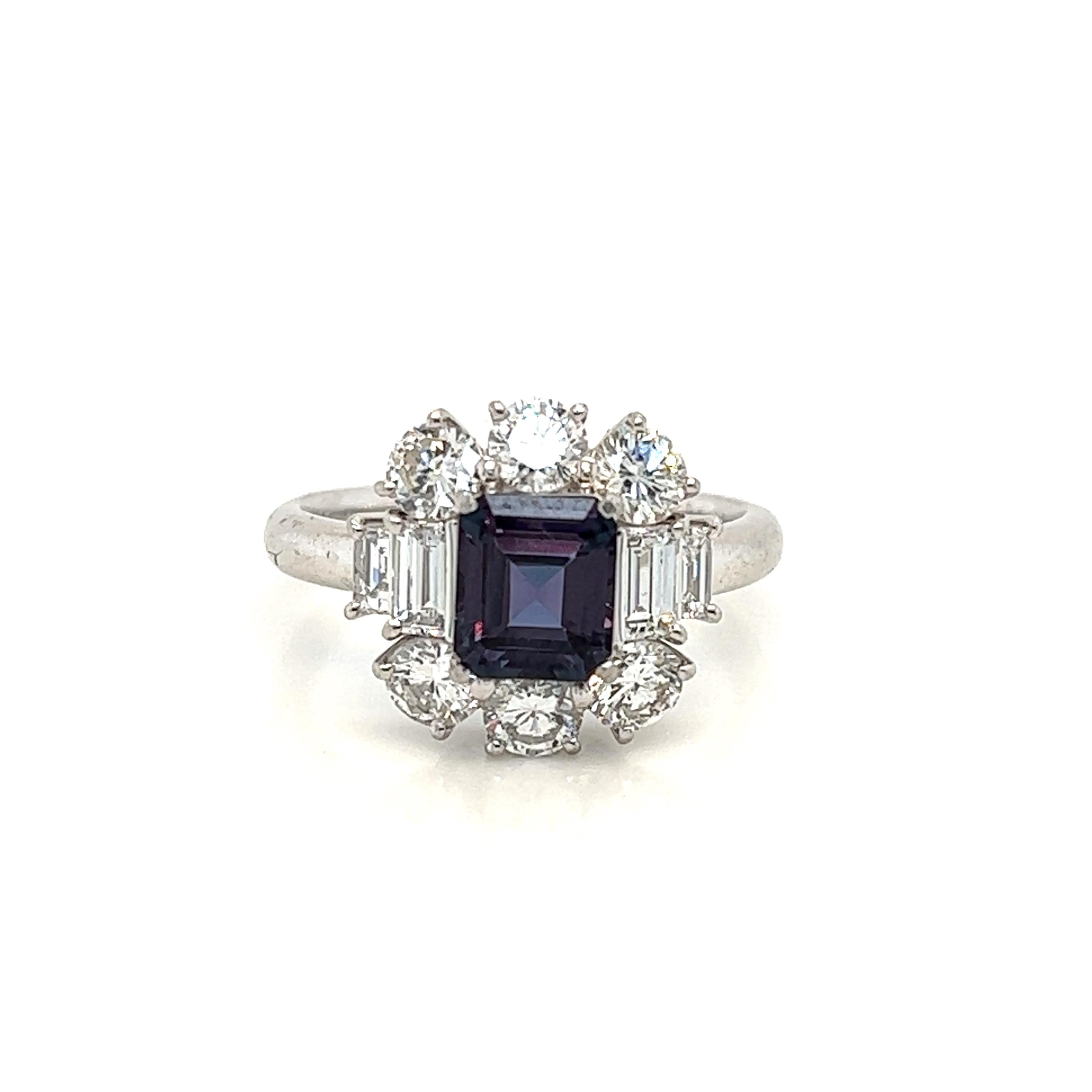 This is a gorgeous natural AAA quality E-Cut Alexandrite surrounded by dainty diamonds that is set in a cocktail platinum setting. This ring features a natural 1.00 carat E-Cut alexandrite that is certified by the Gemological Institute of America