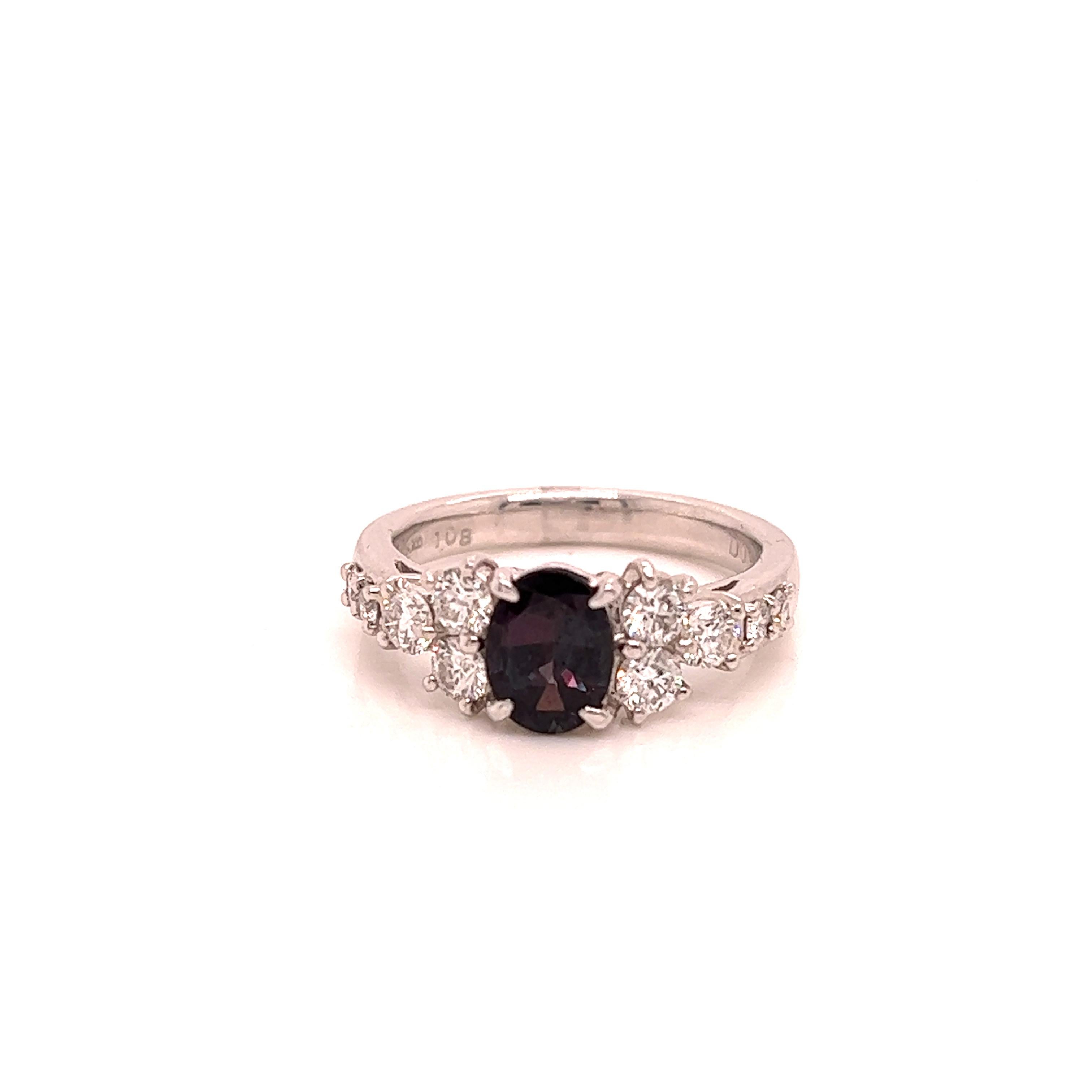 This is a gorgeous natural AAA quality oval Alexandrite surrounded by dainty diamonds that are set in a vintage platinum setting. This ring features a natural 1.08 oval alexandrite that is certified by the Gemological Institute of America (GIA) and