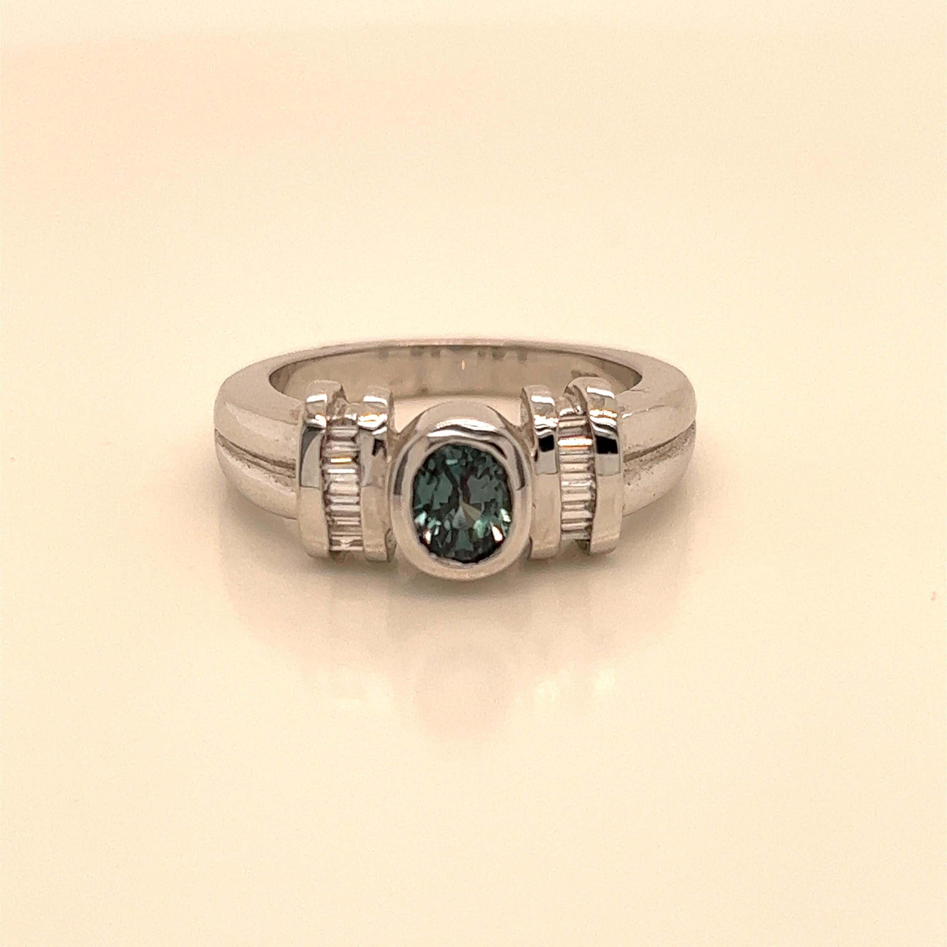 This is a gorgeous natural AAA quality Oval Alexandrite with Baguette diamonds that is set in solid 18K white gold. This ring features a natural 1.11 carat oval alexandrite that is certified by the Gemological Institute of America (GIA). The ring is
