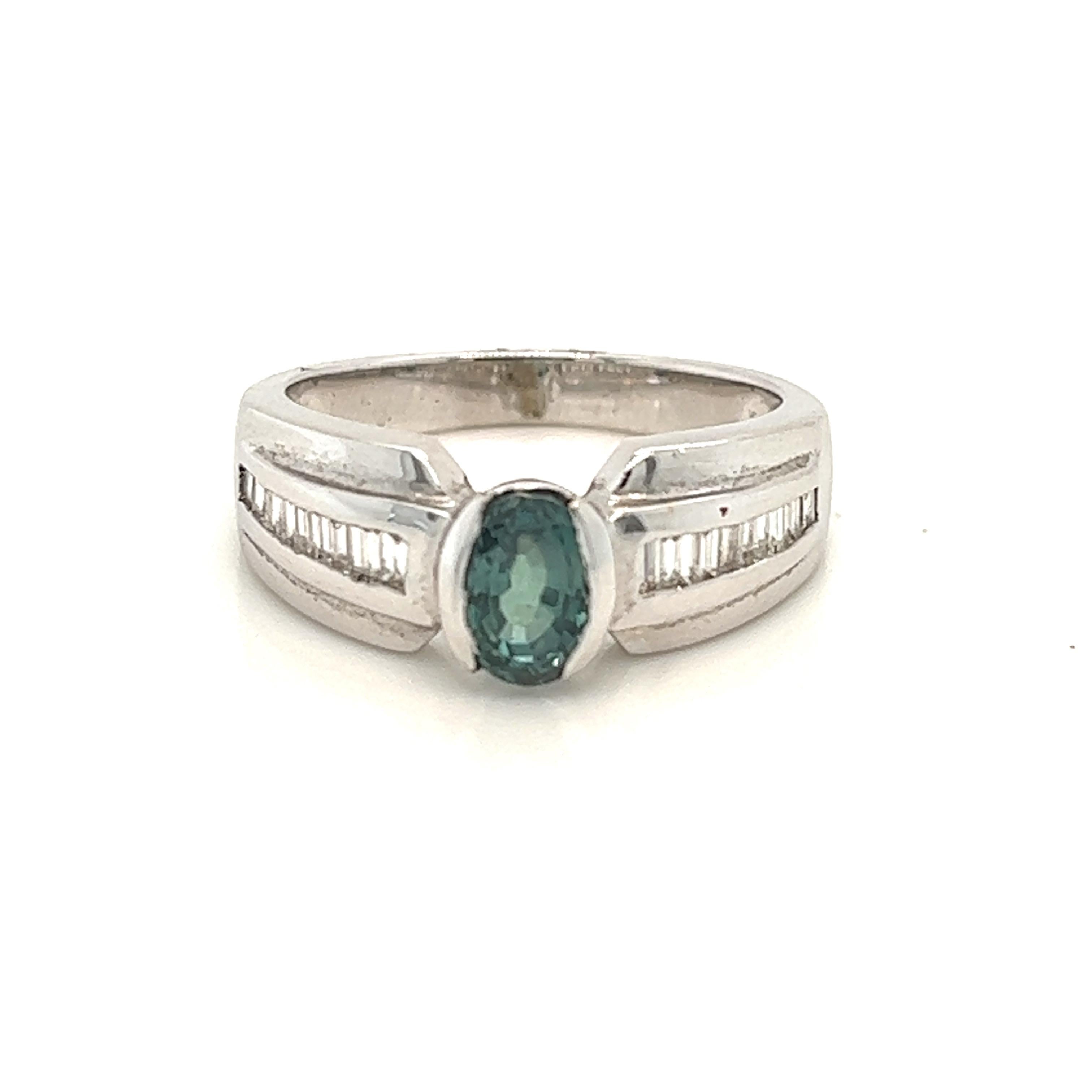 This is a gorgeous natural AAA quality Oval Alexandrite with Baguette diamonds that is set in solid 14K white gold. This ring features a natural 1.21 carat oval alexandrite that is certified by the Gemological Institute of America (GIA). The ring is