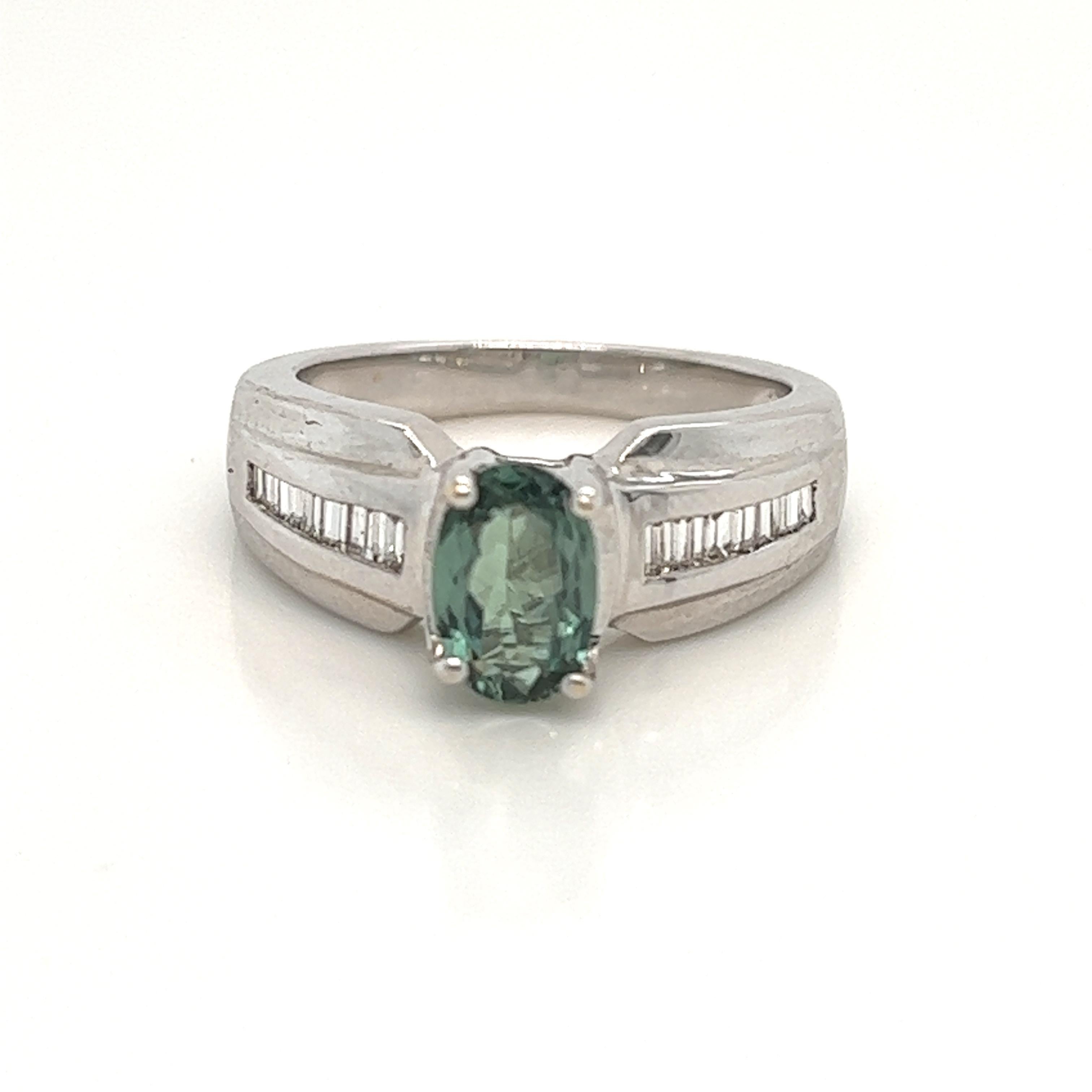 This is a gorgeous natural AAA quality Oval Alexandrite with Baguette diamonds that is set in solid 18K white gold. This ring features a natural 1.21 carat oval alexandrite that is certified by the Gemological Institute of America (GIA). The ring is