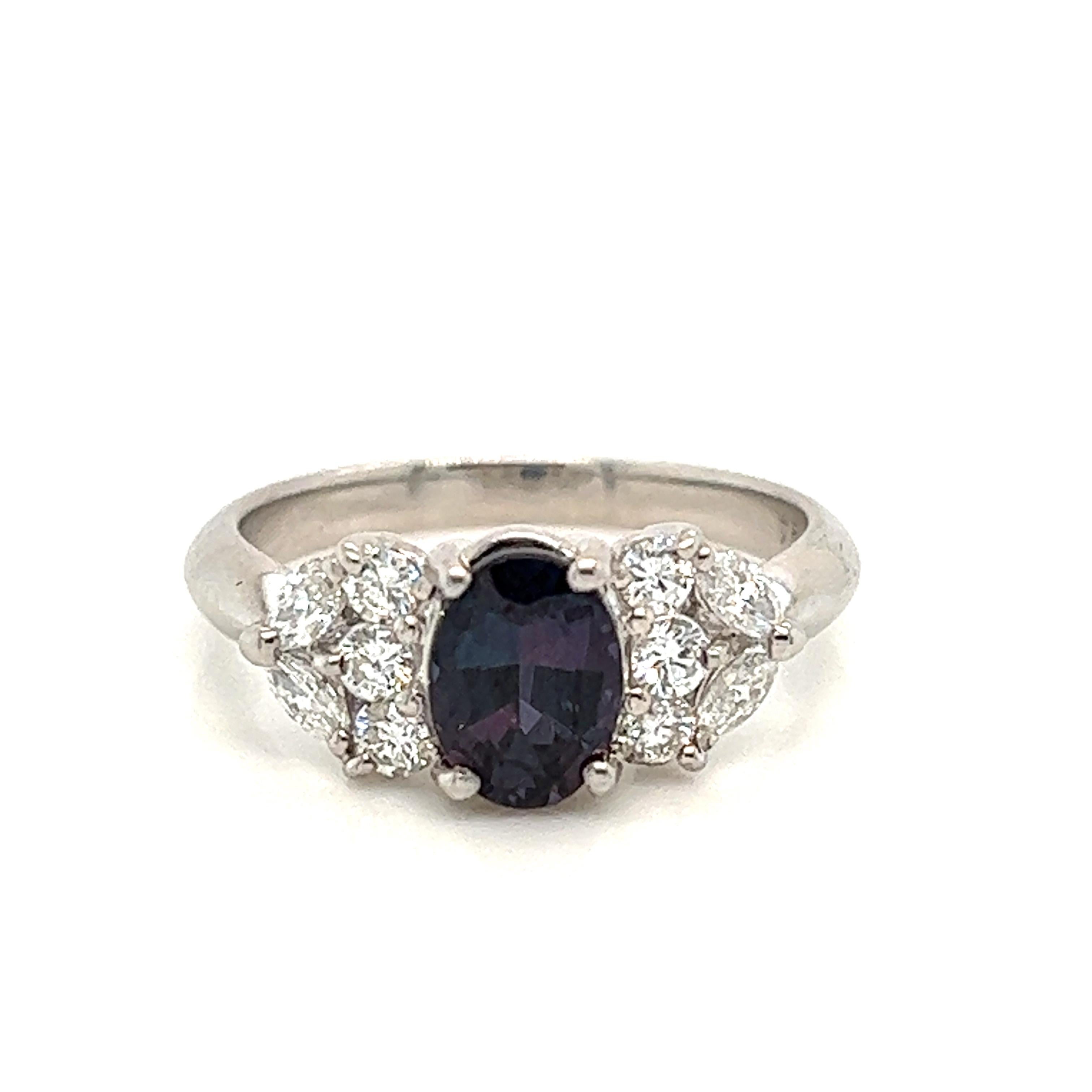This is a gorgeous natural AAA quality oval Alexandrite surrounded by dainty diamonds that is set in a cocktail platinum setting. This ring features a natural 1.24 carat oval alexandrite that is certified by the Gemological Institute of America