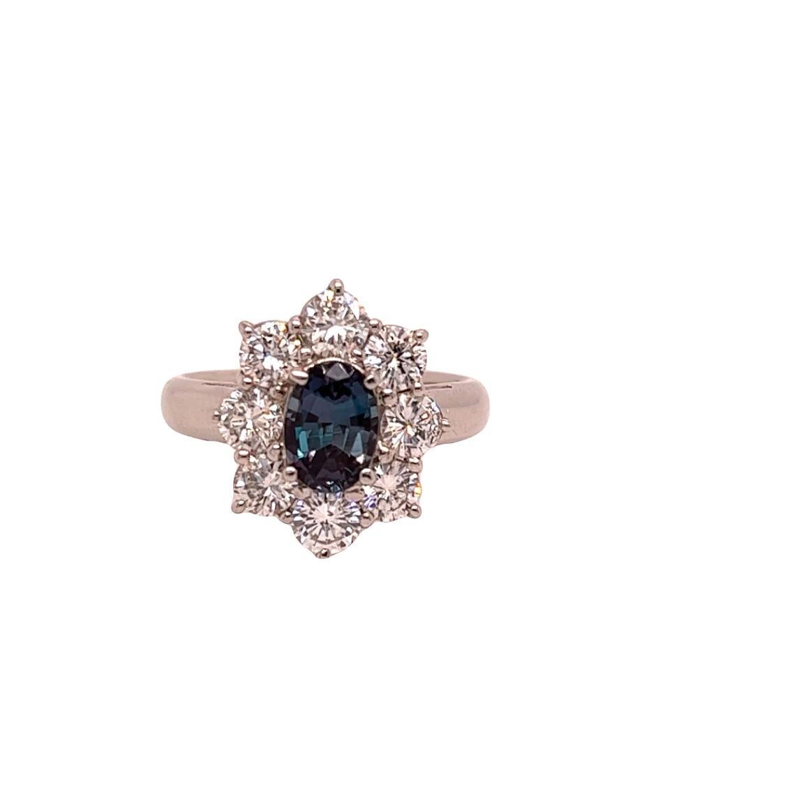 This is a gorgeous natural AAA quality oval Alexandrite surrounded by a dainty diamond halo that is set in a vintage platinum setting. This ring features a natural 1.25 oval alexandrite that is certified by the Gemological Institute of America (GIA)